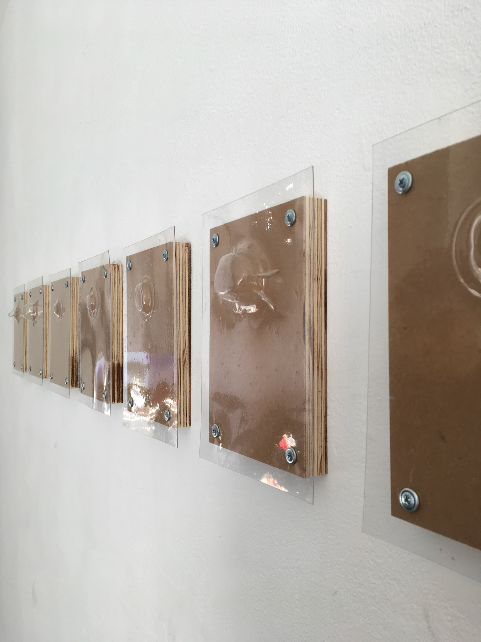 Austin Abistado, Untitled, 2018. MDO, vacuum-formed plastic, plaster of Paris, sheet metal screws.