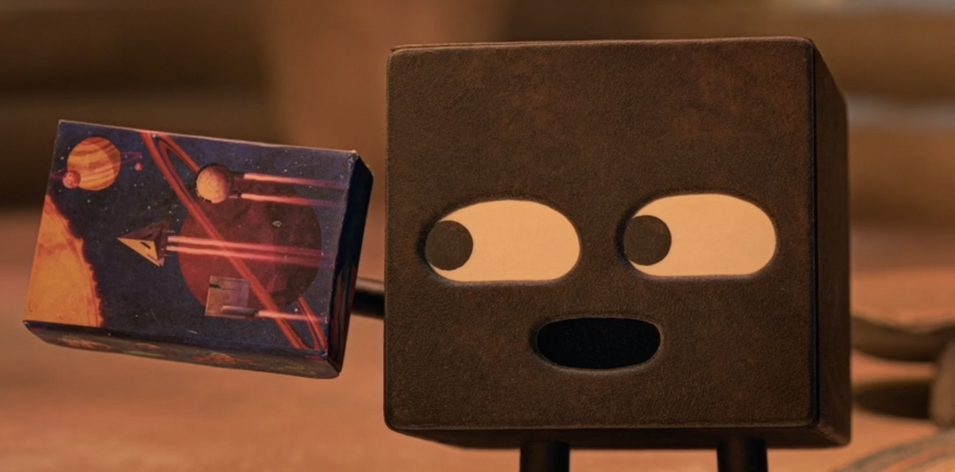 Square holding Stellar Chronicles box - movie still