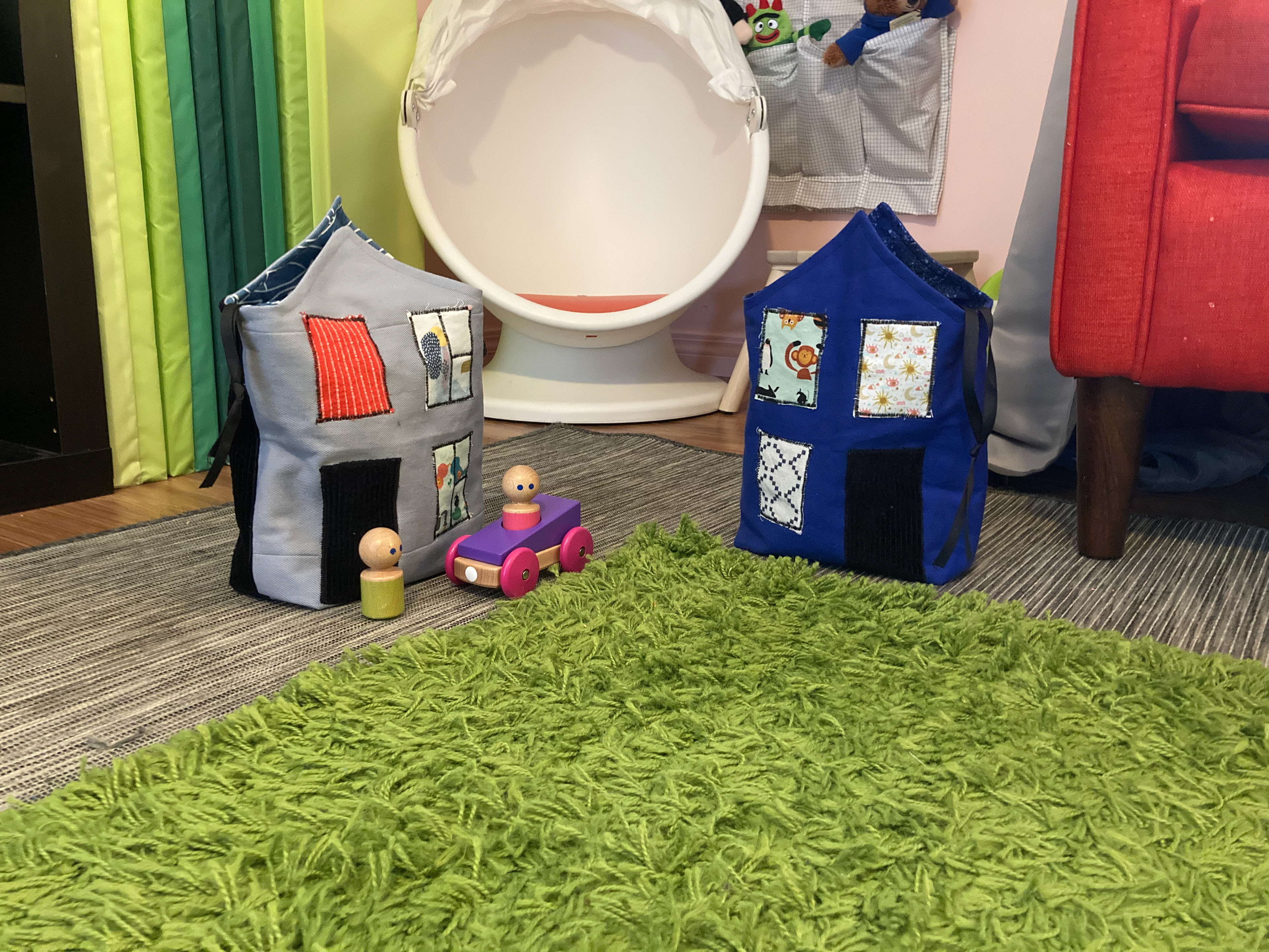 Two handmade bags shaped like houses.