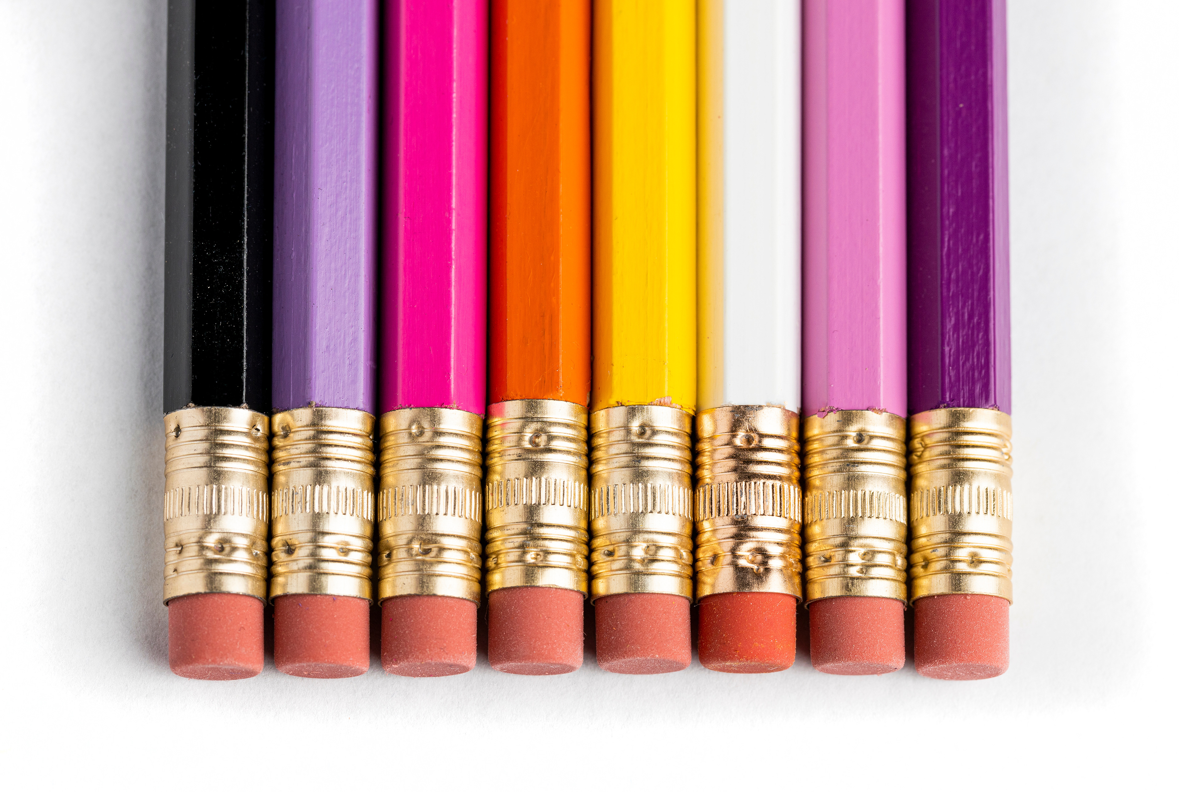 Photo of eraser ends of a set of rainbow pencils