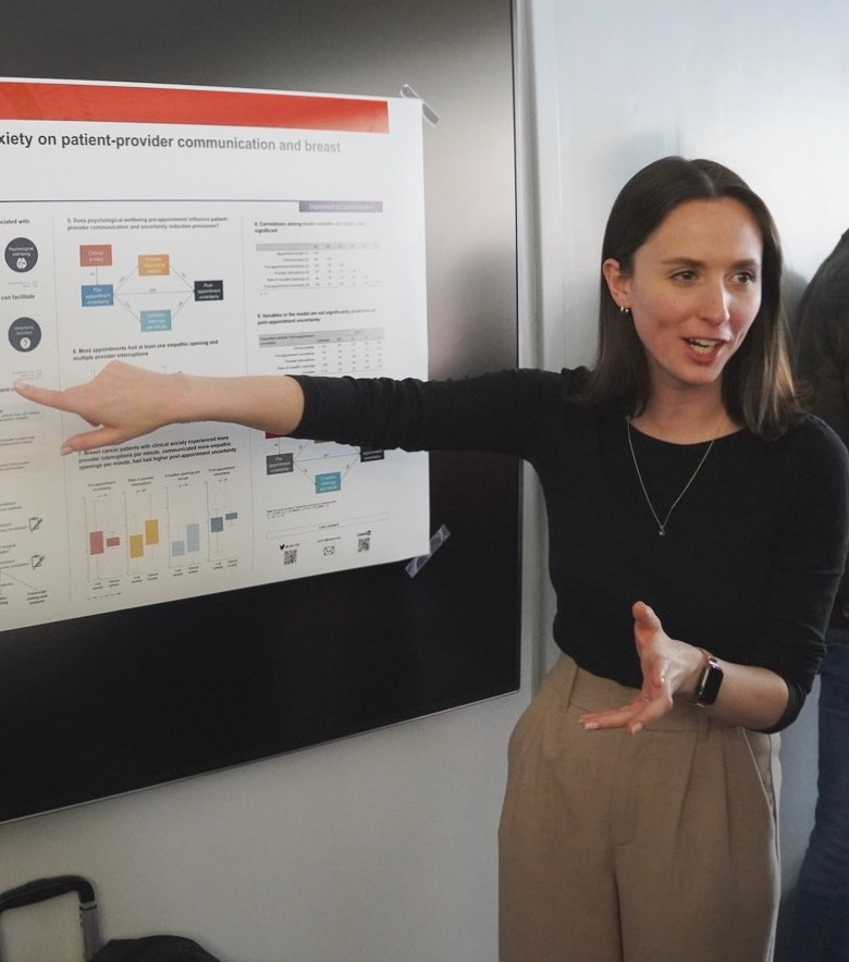 A photo of Liesl presenting a poster