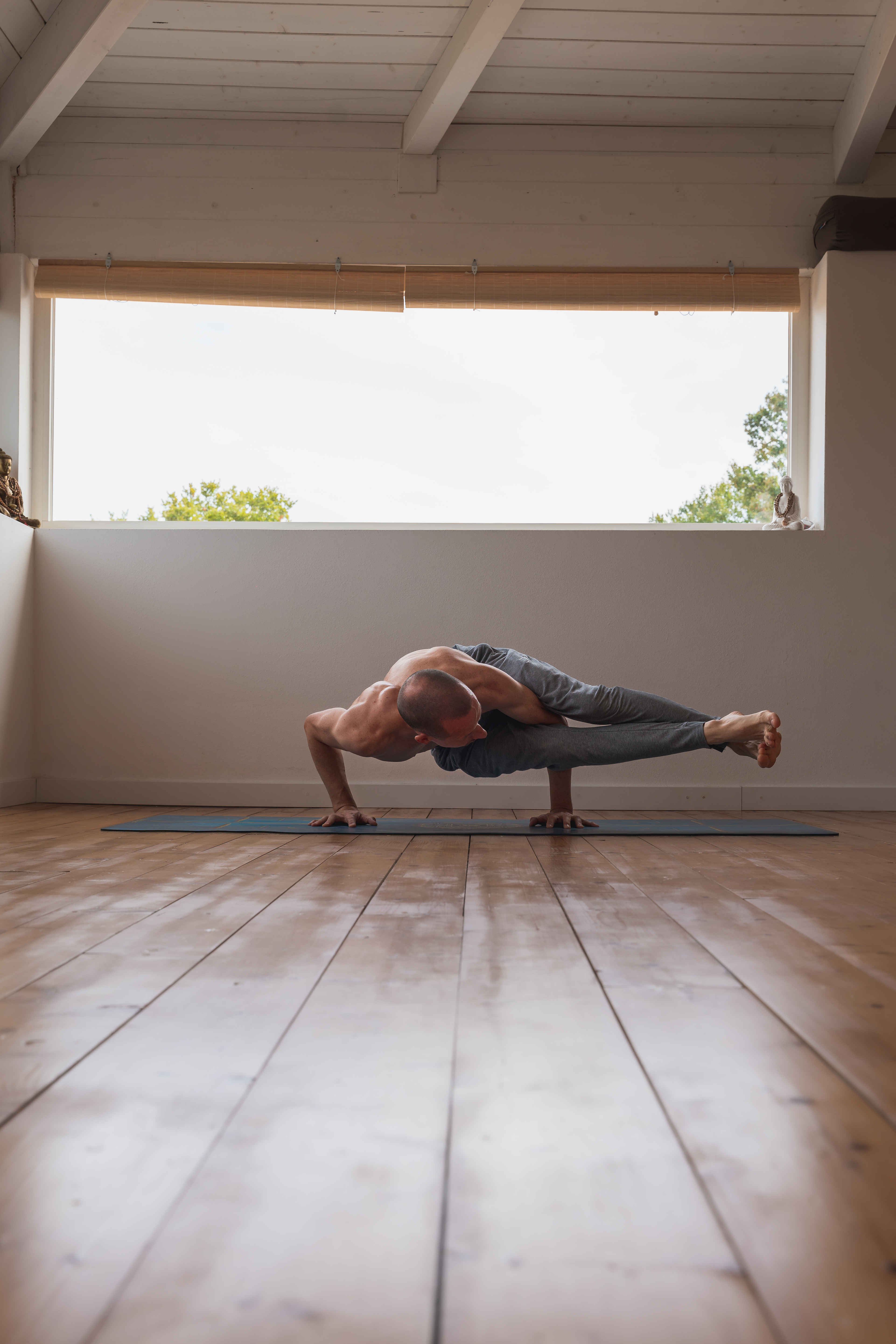 Patrick in the eight angle yoga pose