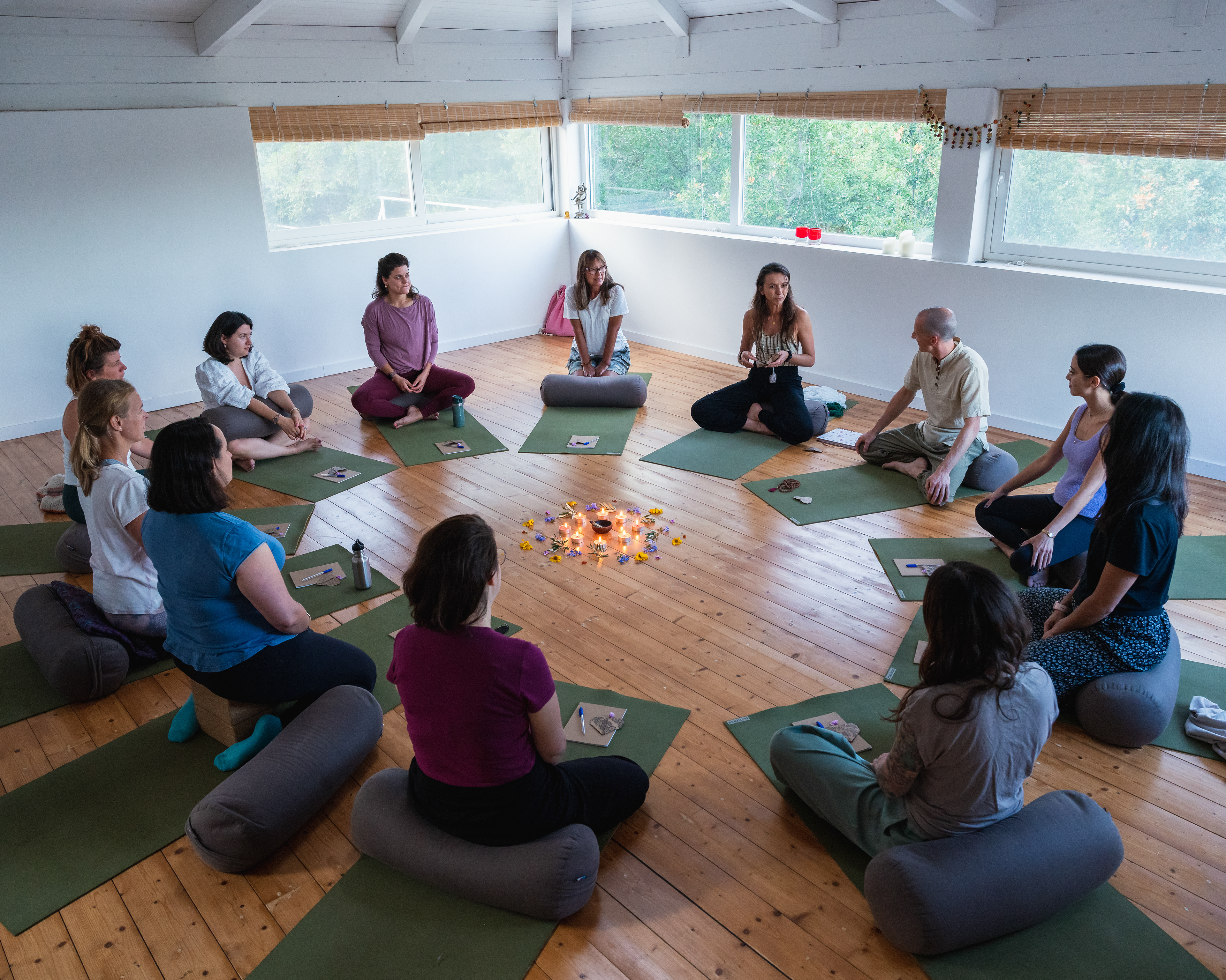 Group sitting in a circle at the yoga retreat in the shala