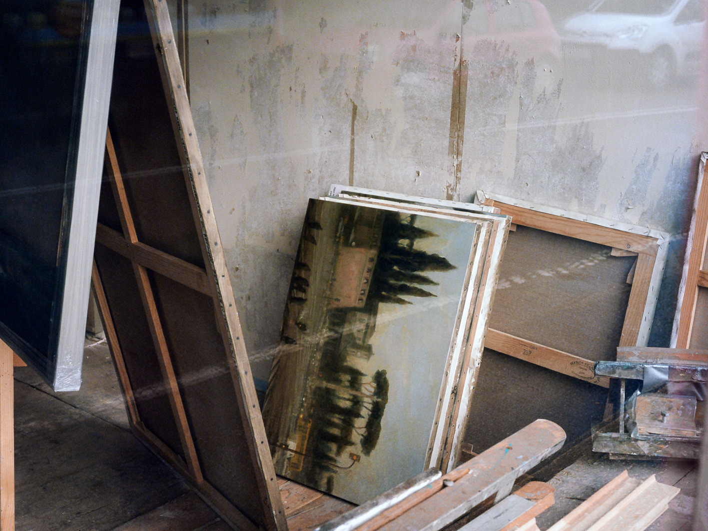 A reflection in a window of a romanticism style painting. A calming and ambient photograph with subtle modern disruptions such as car reflections. A medium format landscape photograph taken by Bristol based photographer Jake Hitchcock