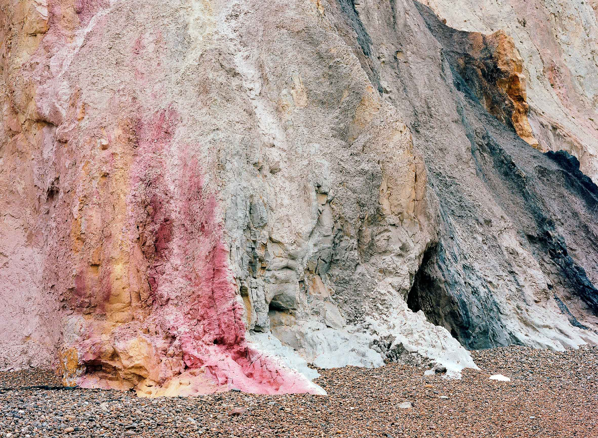 The famous pink and orange cliffs at Alum Bay, Isle of Wight. A close up landscape photograph showing the detail. A medium format photograph taken by Bristol based photographer Jake Hitchcock.