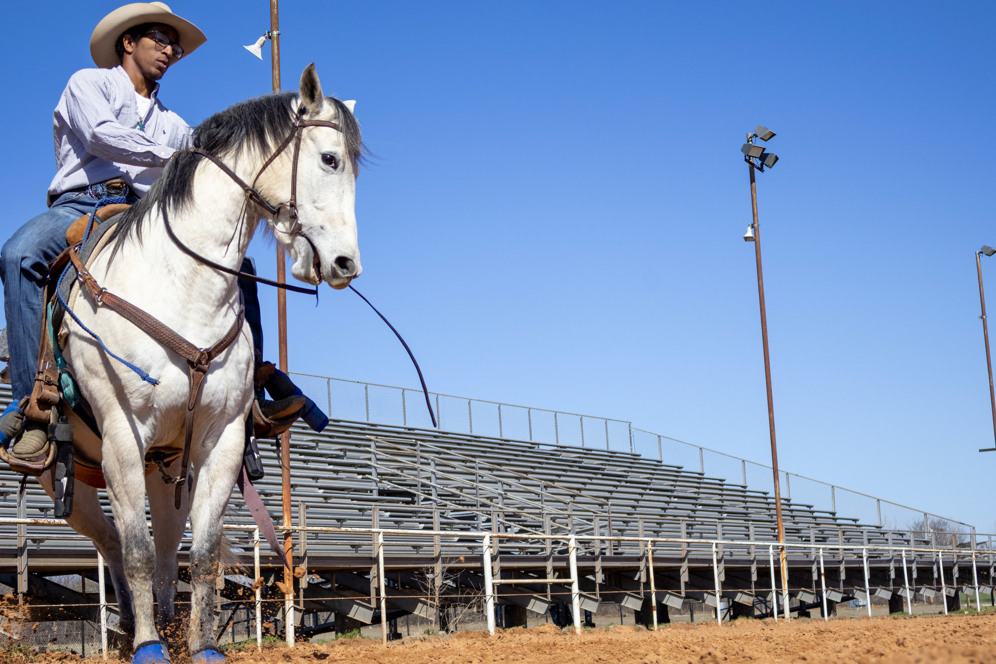 Breakaway roper, Tre Goff, halts his horse, Craig, to a stop in the Bob Arrington Arena. Lauren Sicking
