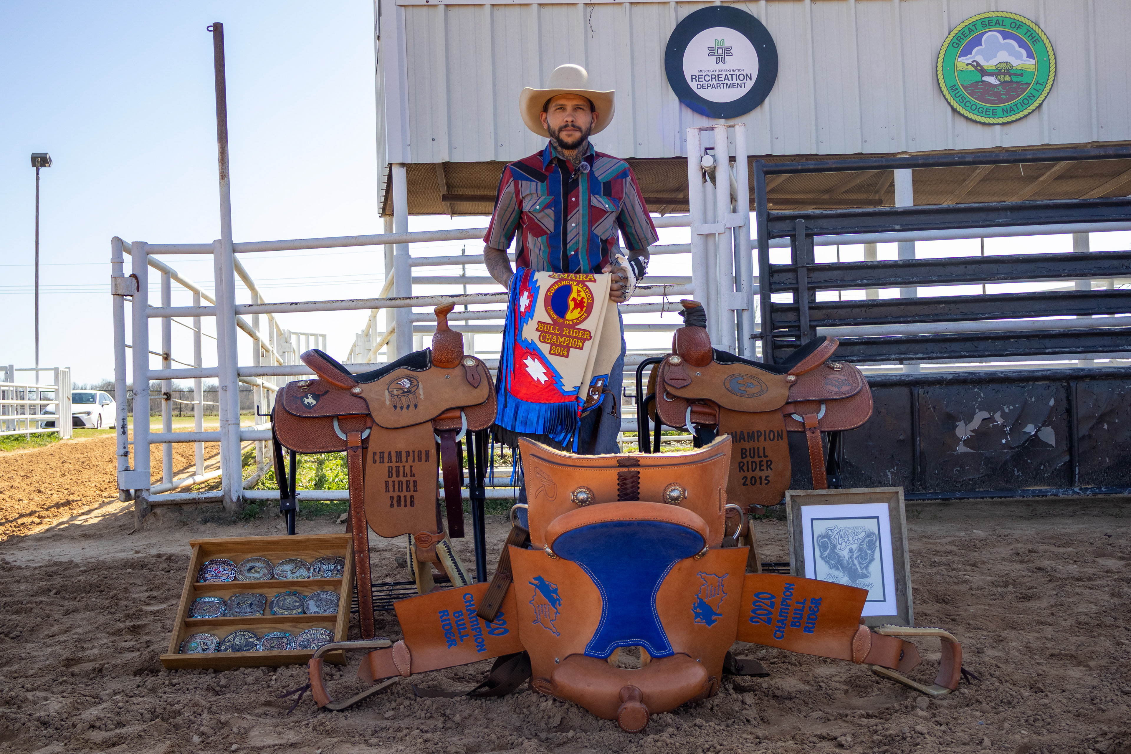 Ryan Roberts, 29, stands with a variety of prizes he has won via bull riding. Lauren Sicking