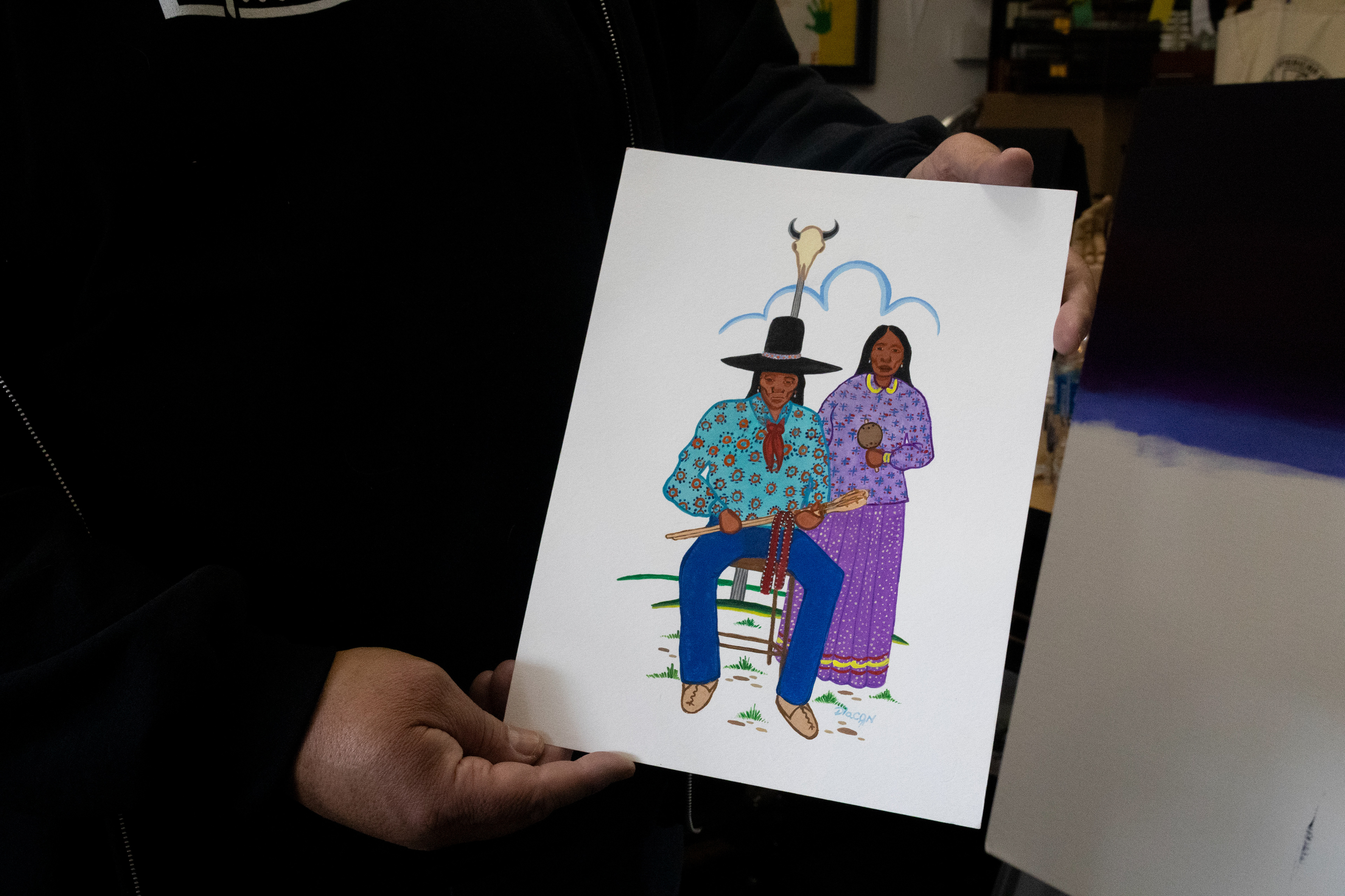  Diacon holding a painting of Muscogee citizens. Elena Andra Stoica