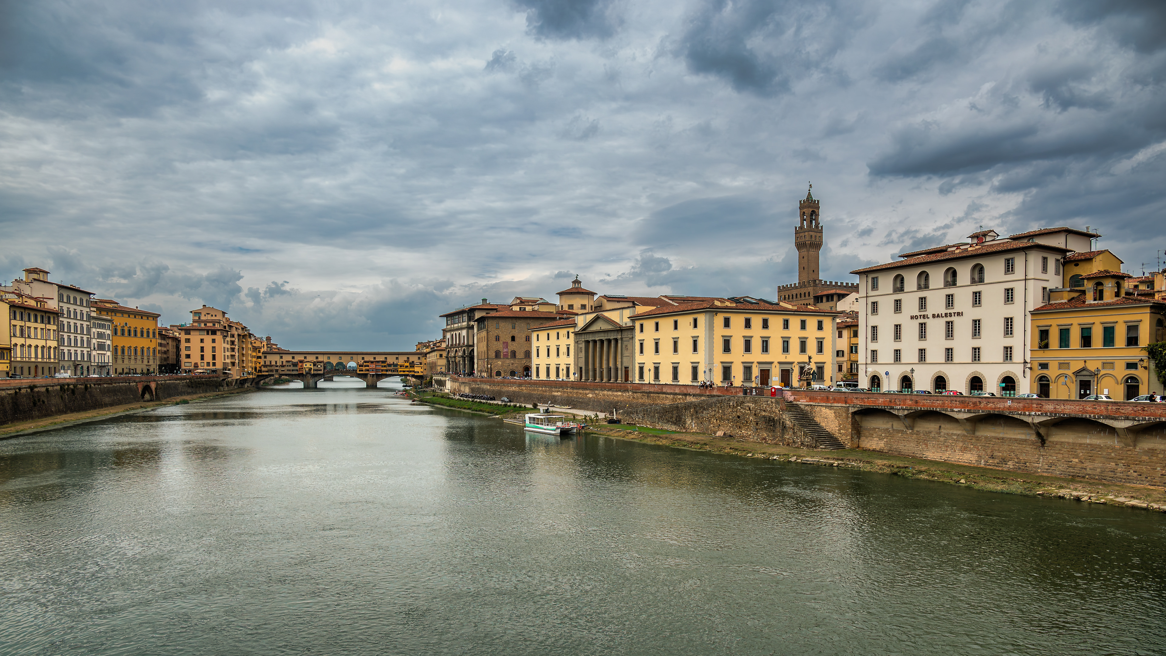 Along the Arno Florence reveals its quieter side beneath dramatic Tuscan skies.