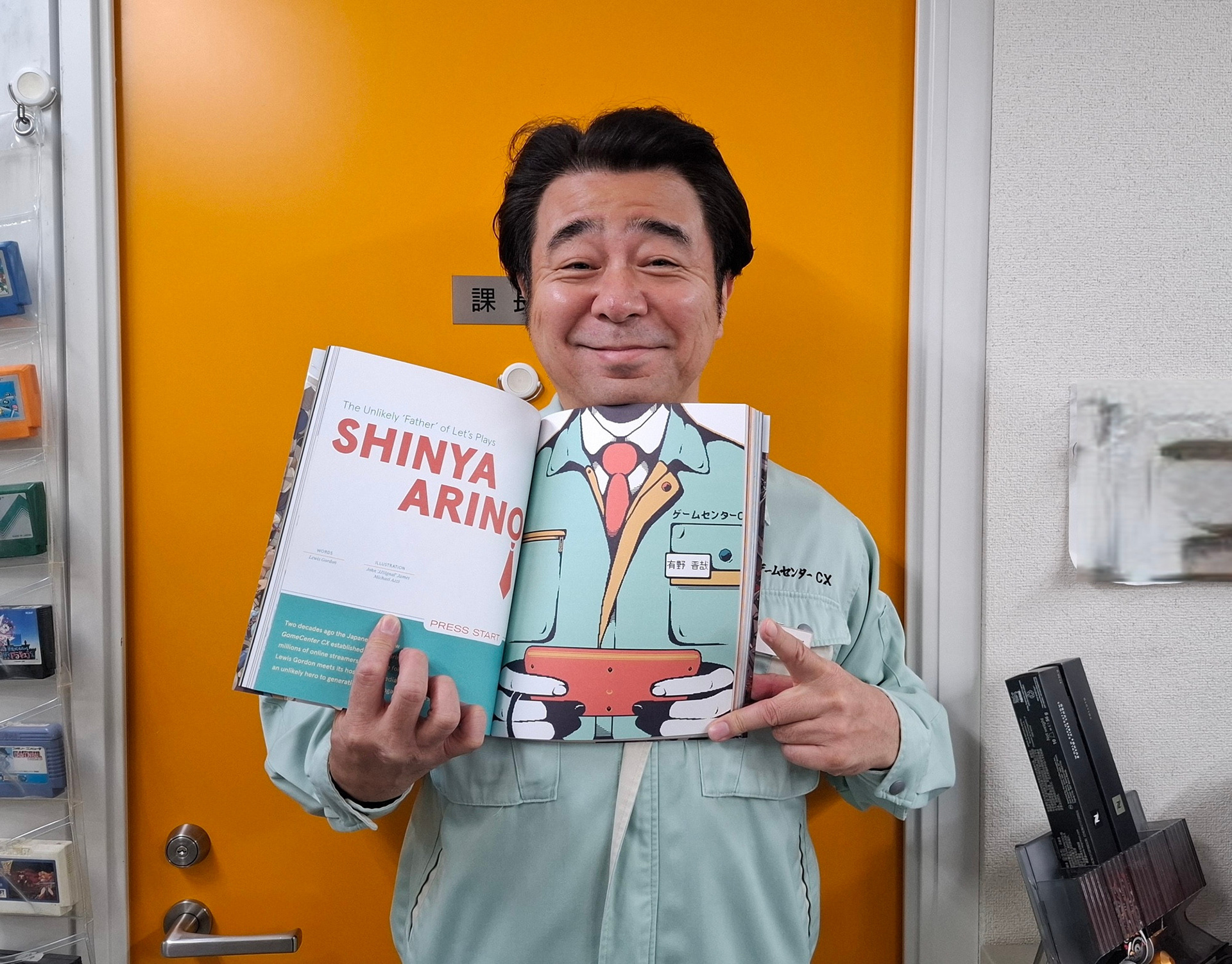 Shinya Arino matching his head up with his copy of APWOT Issue 5