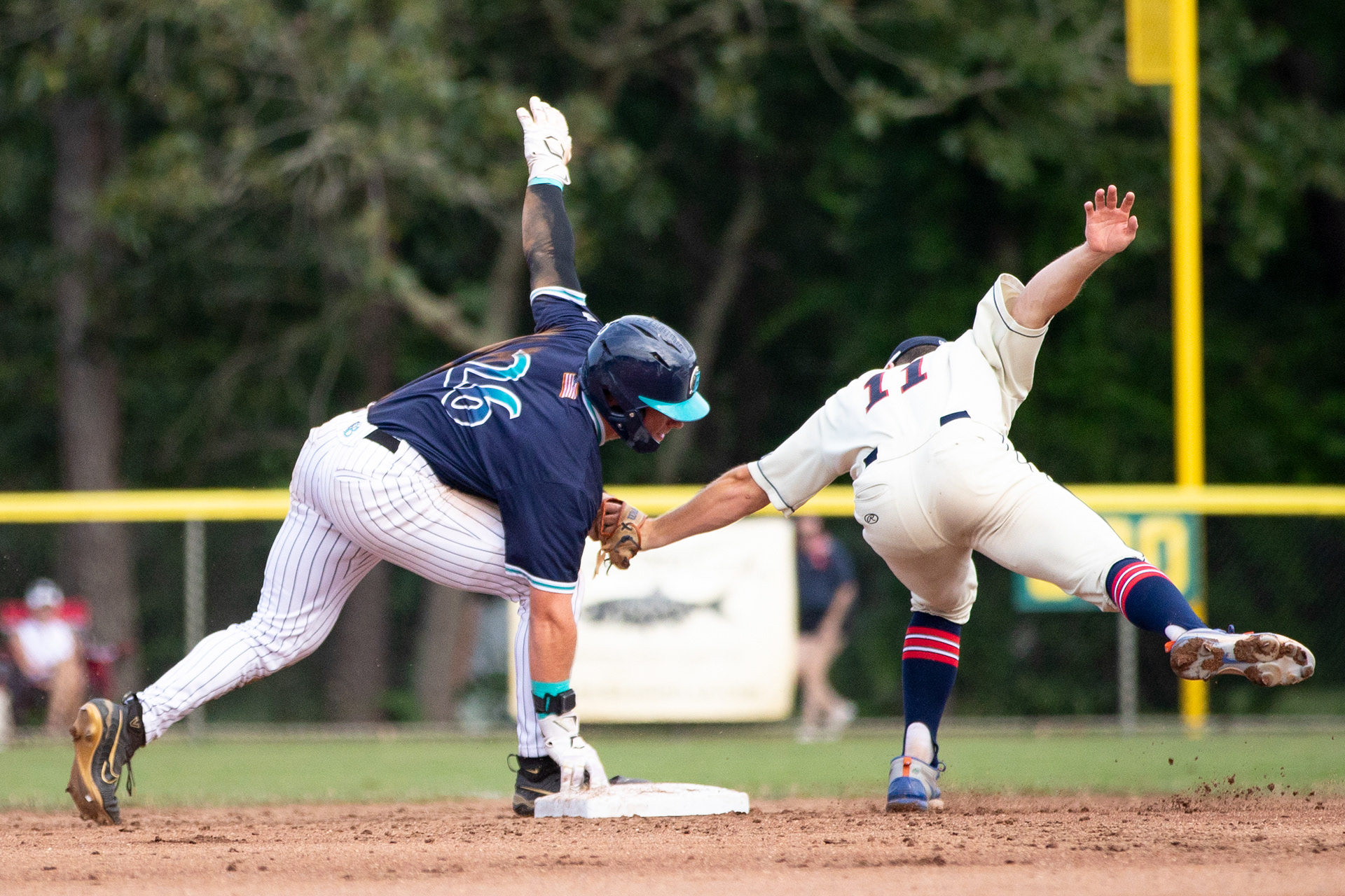Brewster Whitecaps OF JD Rogers (26) balances on second base while Harwich Mariners 2B Cade Kurland (11) applies the tag during the game against the Mariners at Whitehouse Field in Harwich, Massachusetts on July 4, 2024.