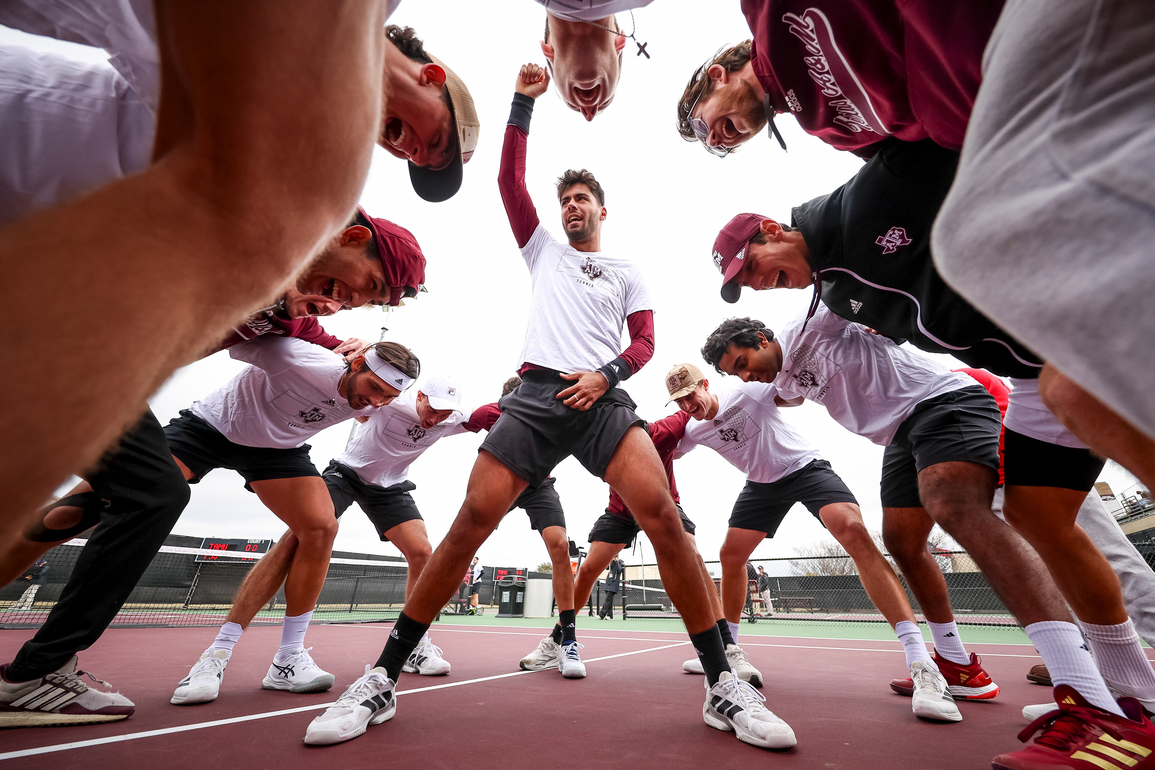 Togan Togac of the Texas A&M Aggies leads a pregame huddle before the team's match against Florida State at the Mitchell Tennis Center in College Station, Texas on February 23, 2025.