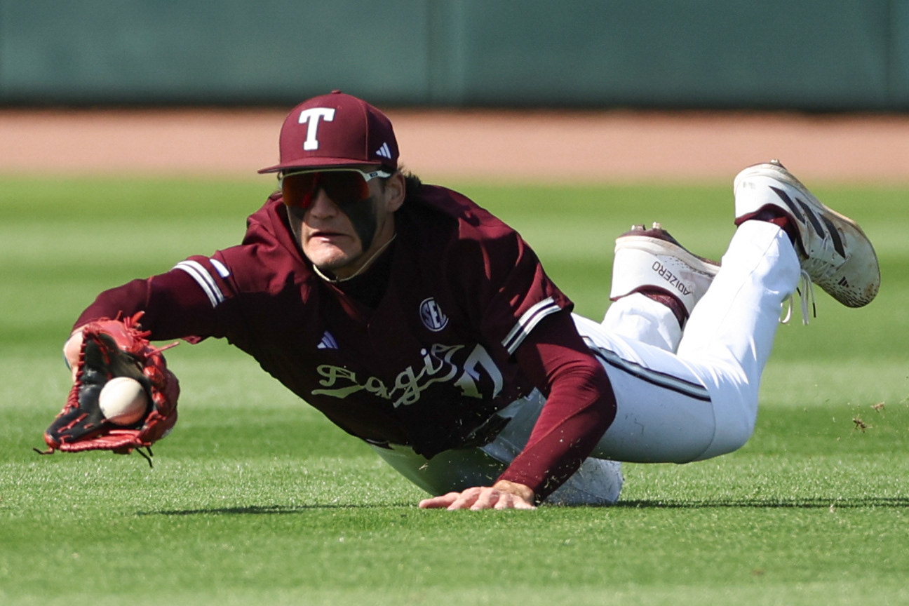 Texas A&M OF Jace Laviolette (17) makes a diving catch during the game against the University of Rhode Island Rams at Blue Bell Park in College Station, Texas on March 9, 2024. 