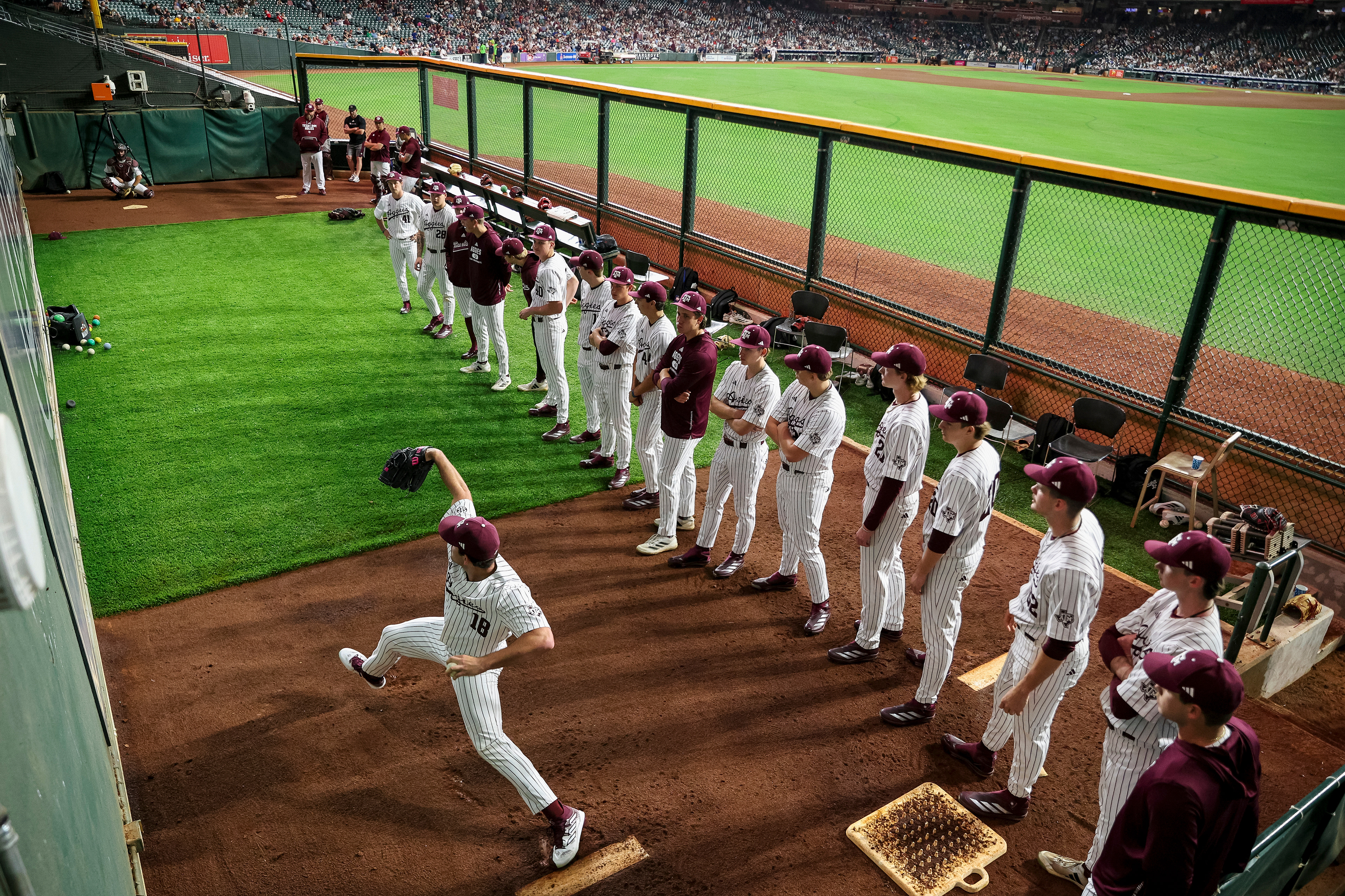 Texas A&M P Ryan Prager (18) throws warm up pitches before the game against the University of Arizona at Daikin Park in Houston, Texas on February 28, 2025.