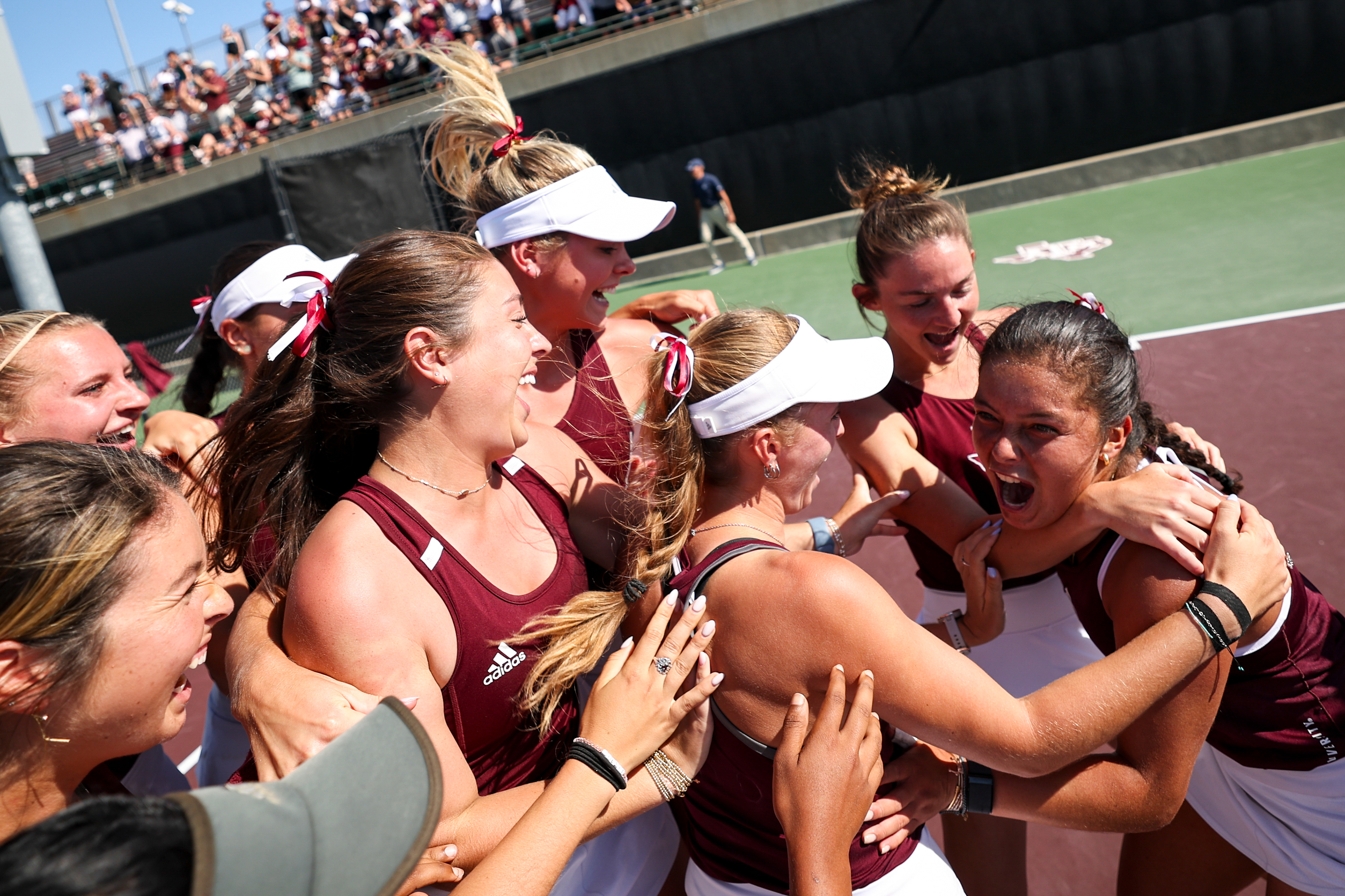 The Texas A&M women's tennis team celebrate Luciana Perez's match winning game against Georgia to win the regular season SEC title at the Mitchell Tennis Center in College Station, Texas on April 15, 2025. 