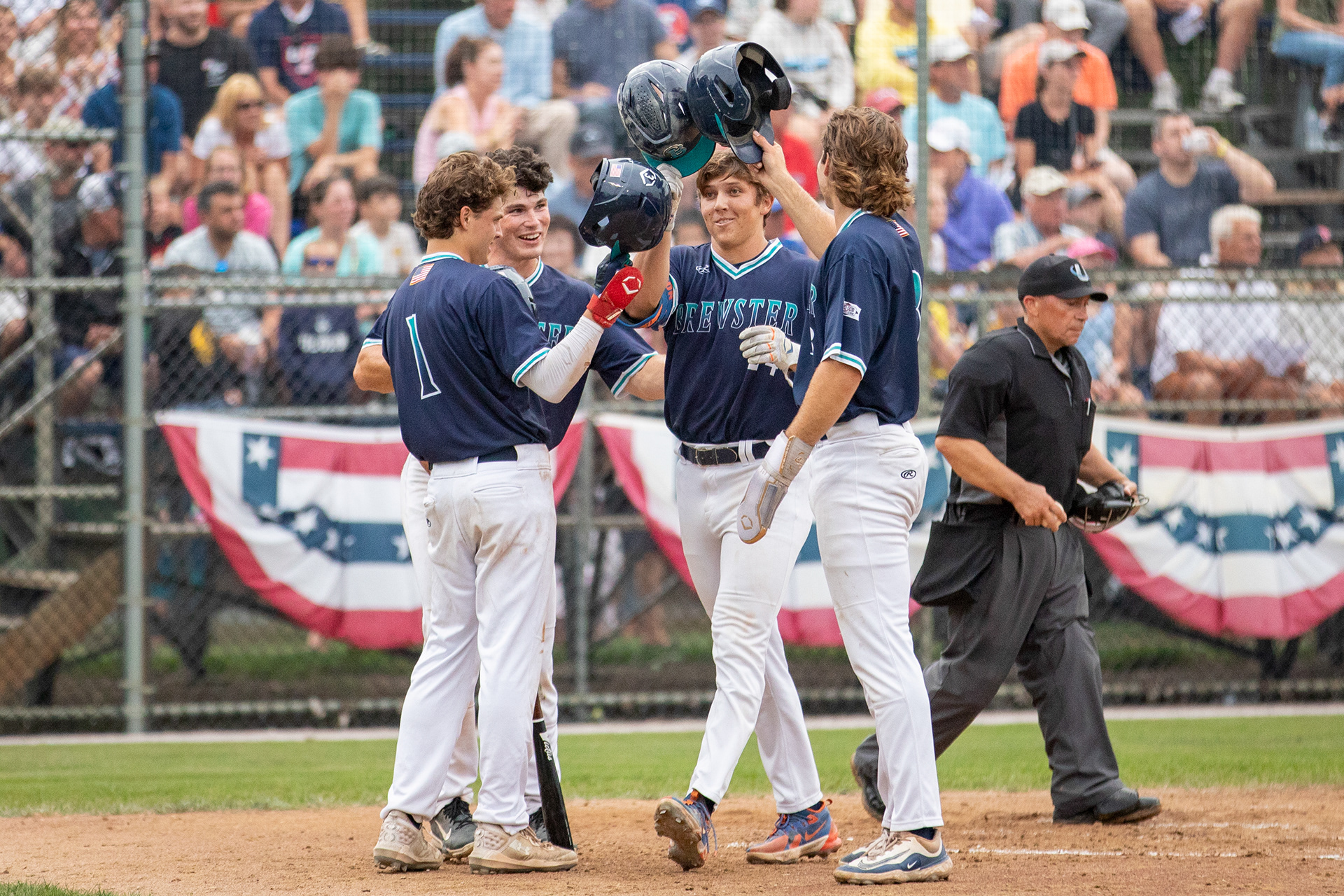 Brewster Whitecaps players 3B Colby Shelton (24), OF Dallas Macias (4), DH Michael Iannazzo (1), SS Drew Faurot (3) celebrate Shelton's homerun during the game against the Harwich Mariners at Whitehouse Field in Harwich, Massachusetts on August 4, 2024.