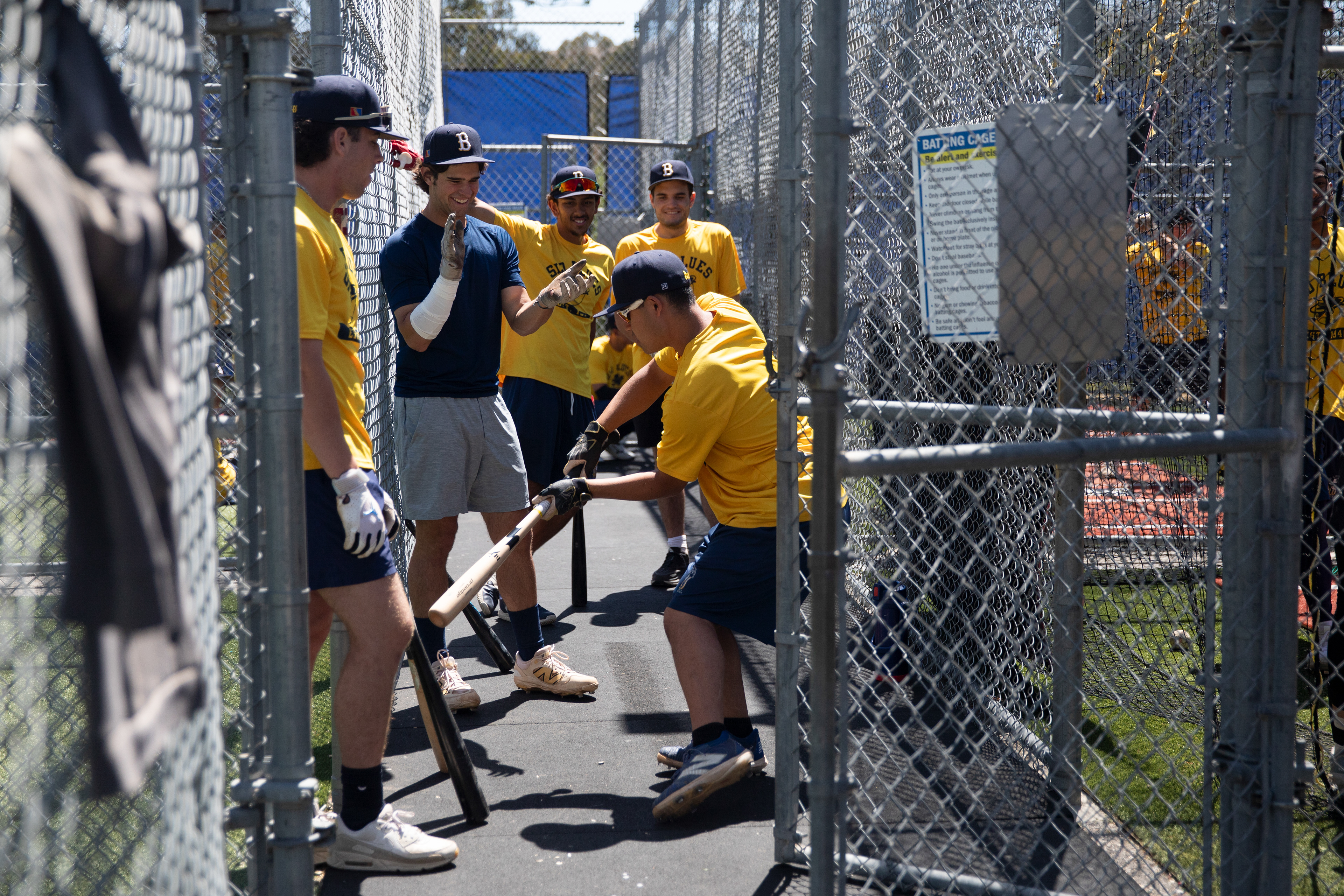 SLO Blues players OF Mason Ashlock (51), SS Cade O'Hara (1), 2B Diego Murillo (7), and 2B Sean Stirttmatter (15), laugh with OF Kosei Suzuki (25) during batting practice before the game against the  Sonoma Stompers at Sinsheimer Stadium in San Luis Obispo, California on June 18, 2025.