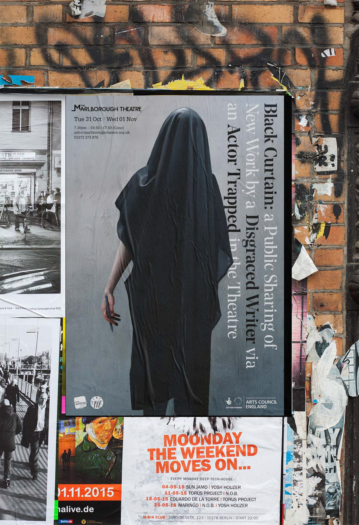 A large Black Curtain poster pasted on a wall in the street next to other event posters