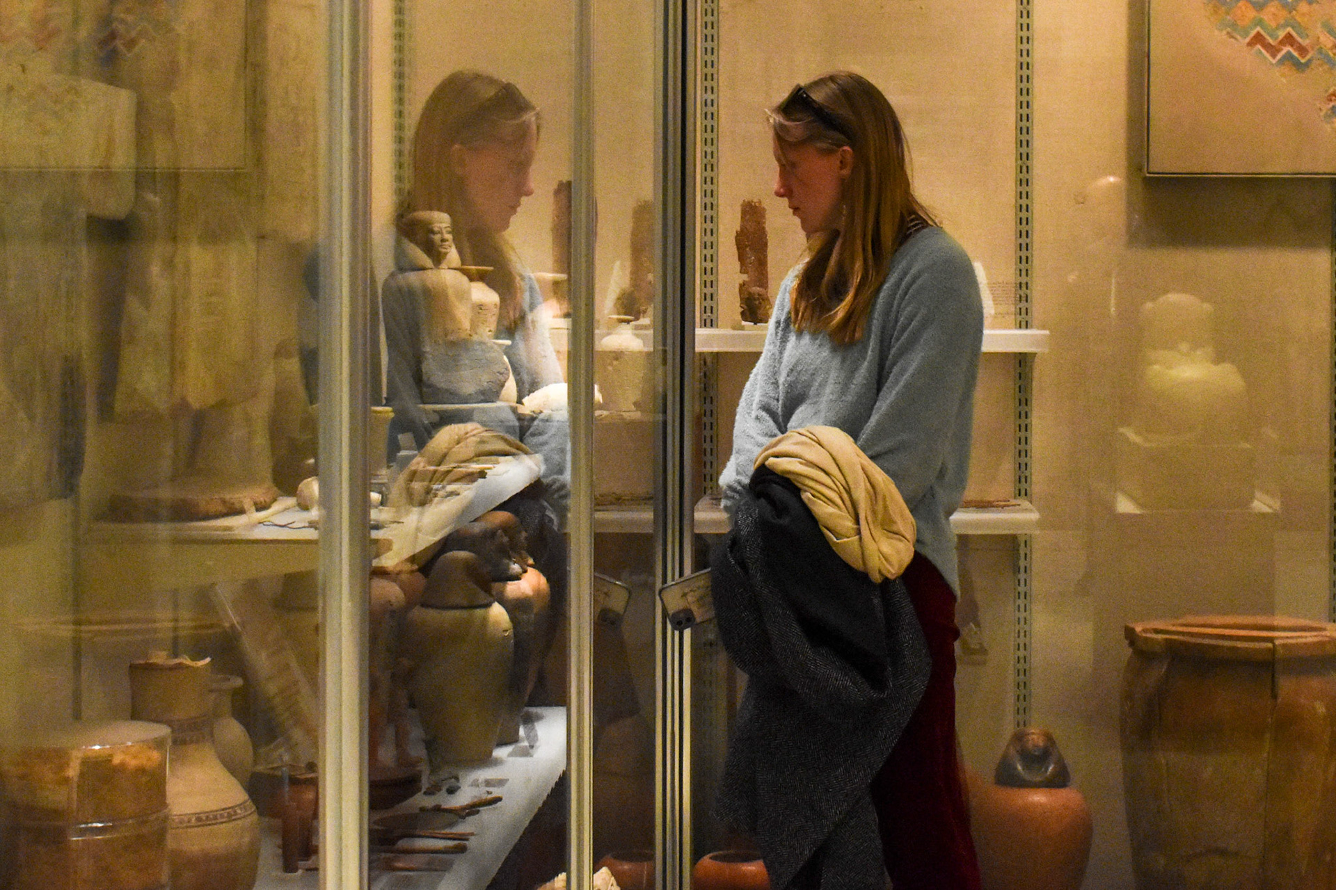 Reflecting: Caroline Bayer studies artifacts in the Ancient Egypt display.