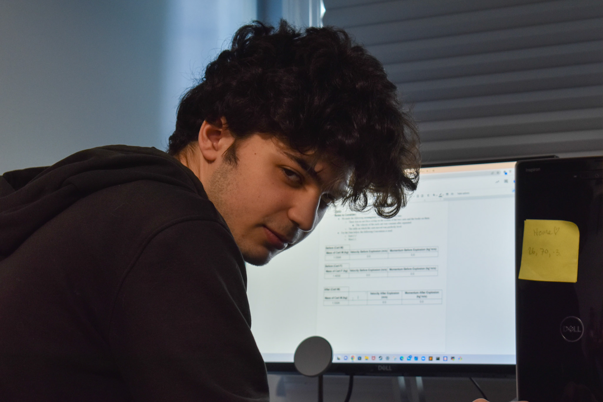 Busy Work: Owen Gartlan was not happy that I was photographing him doing physics homework. A sticky note with the coordinates to our Minecraft house is on his PC.