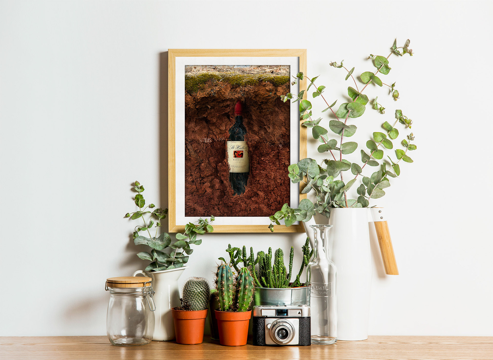 St Hallett Red Wine bottle buried in terra rosa soil. Creative retouching by Paul Munzberg.