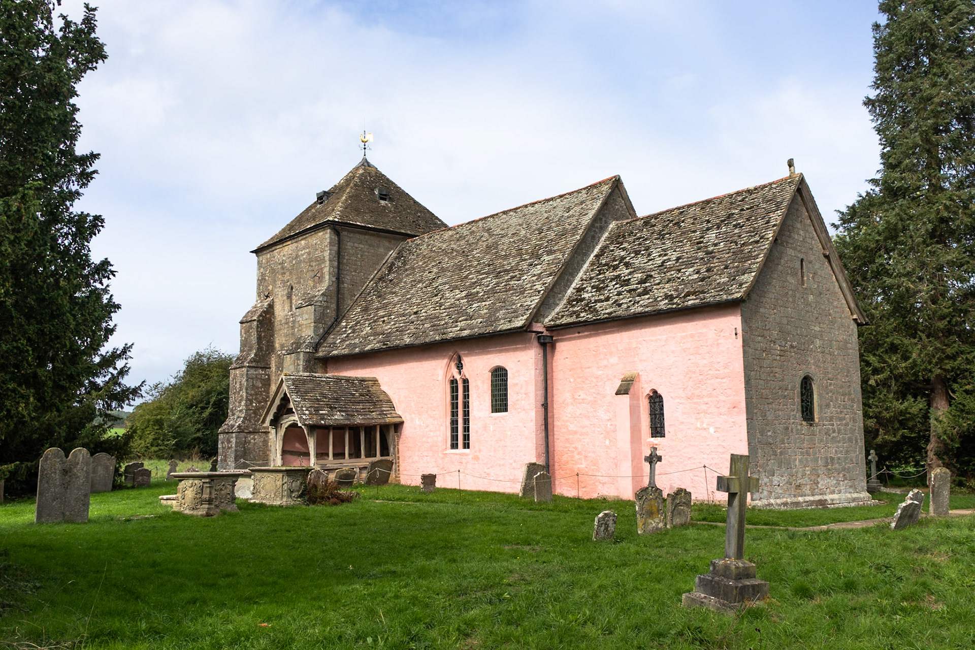 Church at Kempley. Pink colour thought to be from whitewash containing ox blood, which said to preserve the stonework. The great uncle of our host in Wales was involved in restoring the artwork. Oldest wooden door and wooden beams in the UK
