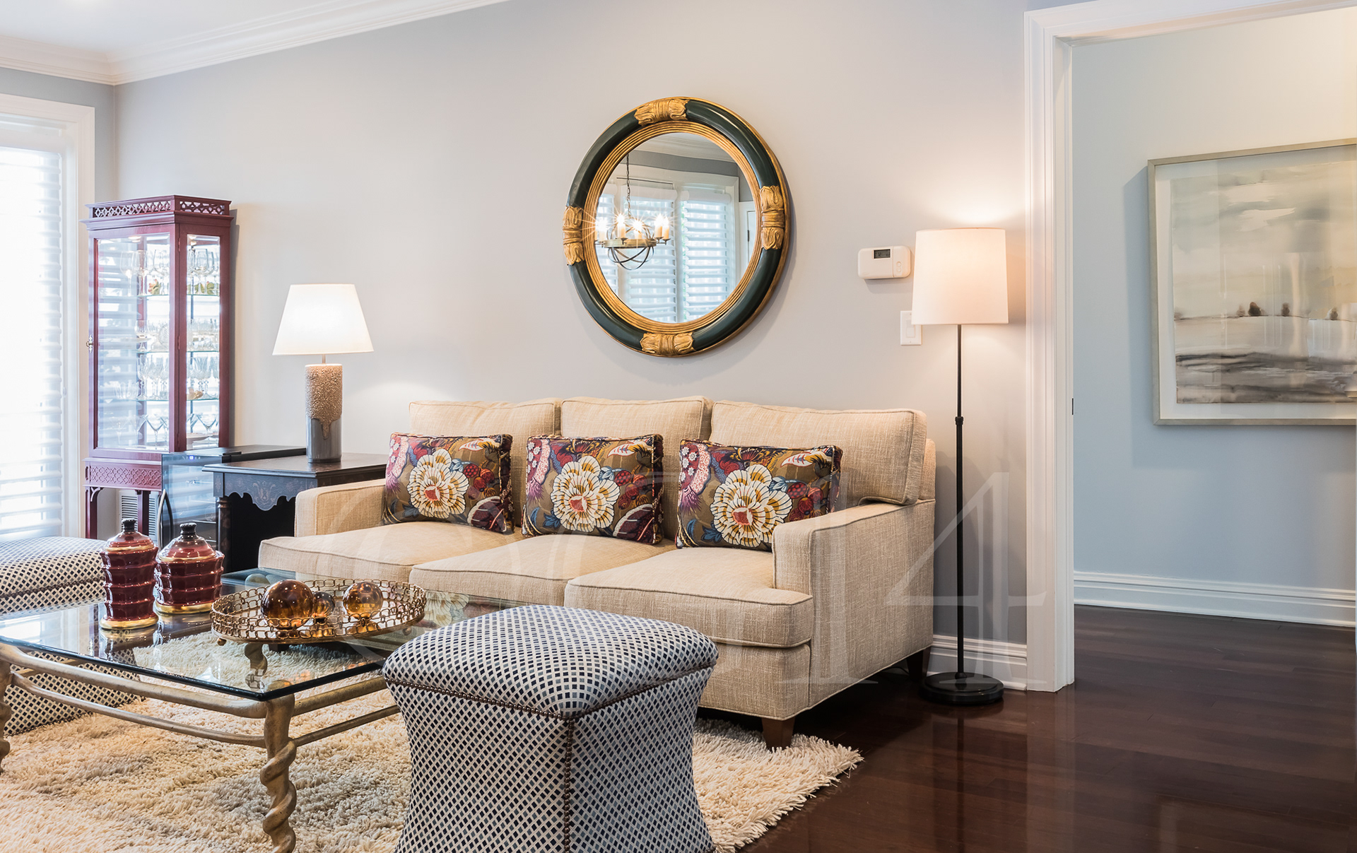 Christine Interiors of Chatham, NJ designed this living room in subtle blues and jewel tones. The dining room below is another design of hers; note the textured wallpaper that complements the chandelier and furniture.