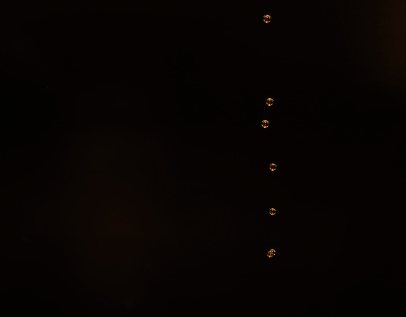 Bubblor stiger mot ytan i ett glas av mindre lycka.