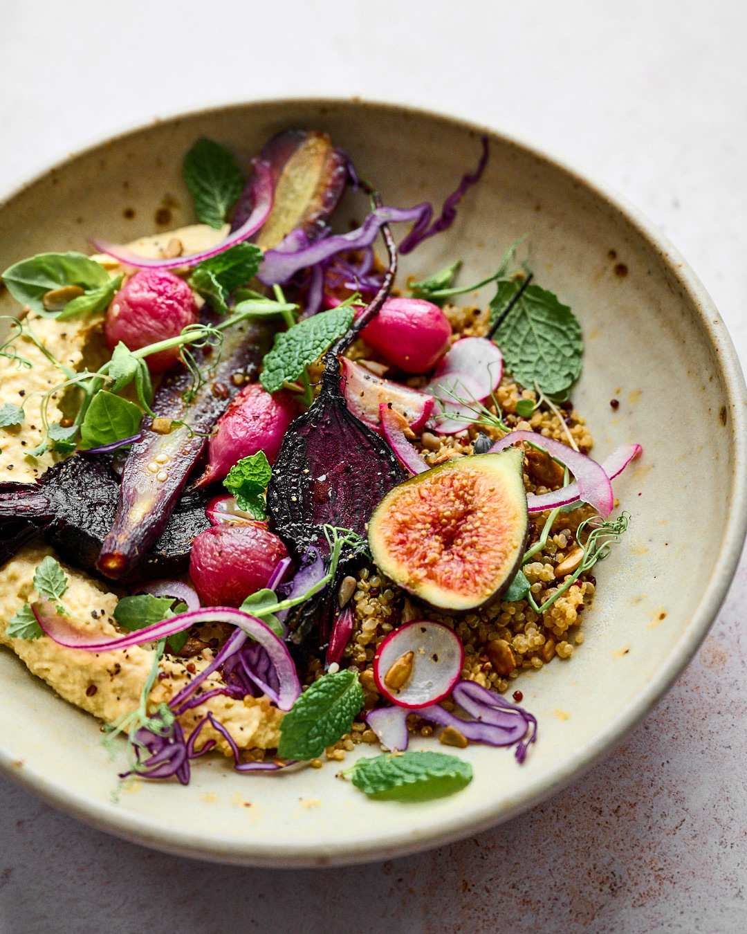 Gorgeous image of a bowl of grains, quinoa and roasted vegetables with figs by Anusha Stewart a food photographer in surrey UK