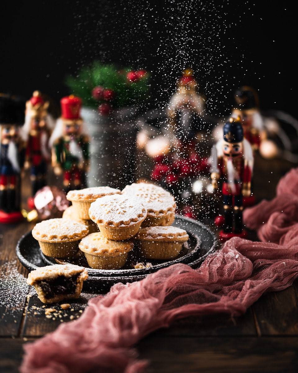 A Christmas food photograph of some mince pies with a dusting of icing powder by Anusha Stewart