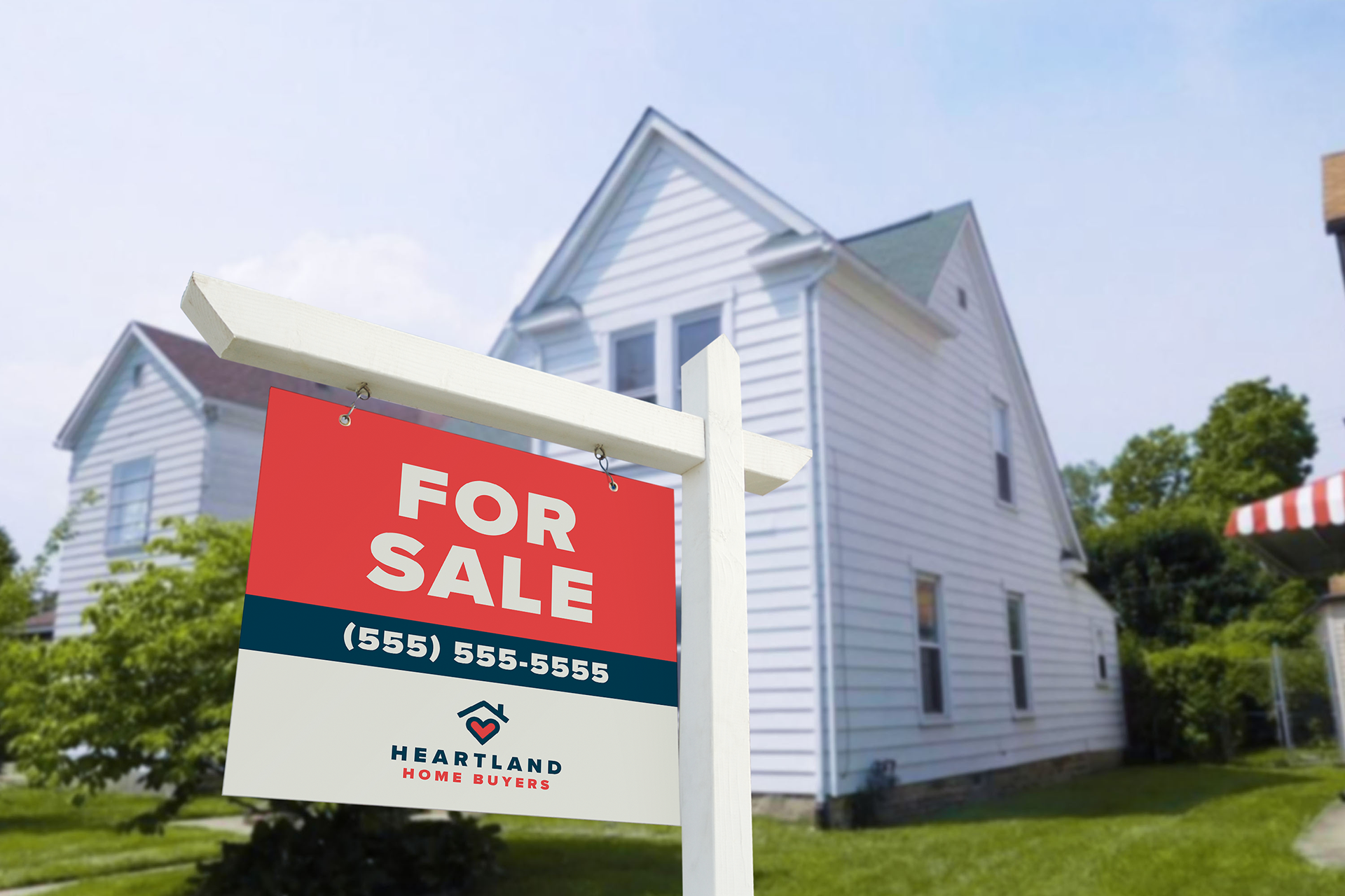 Mockup of a for sale sign with Heartland Home Buyers branding.