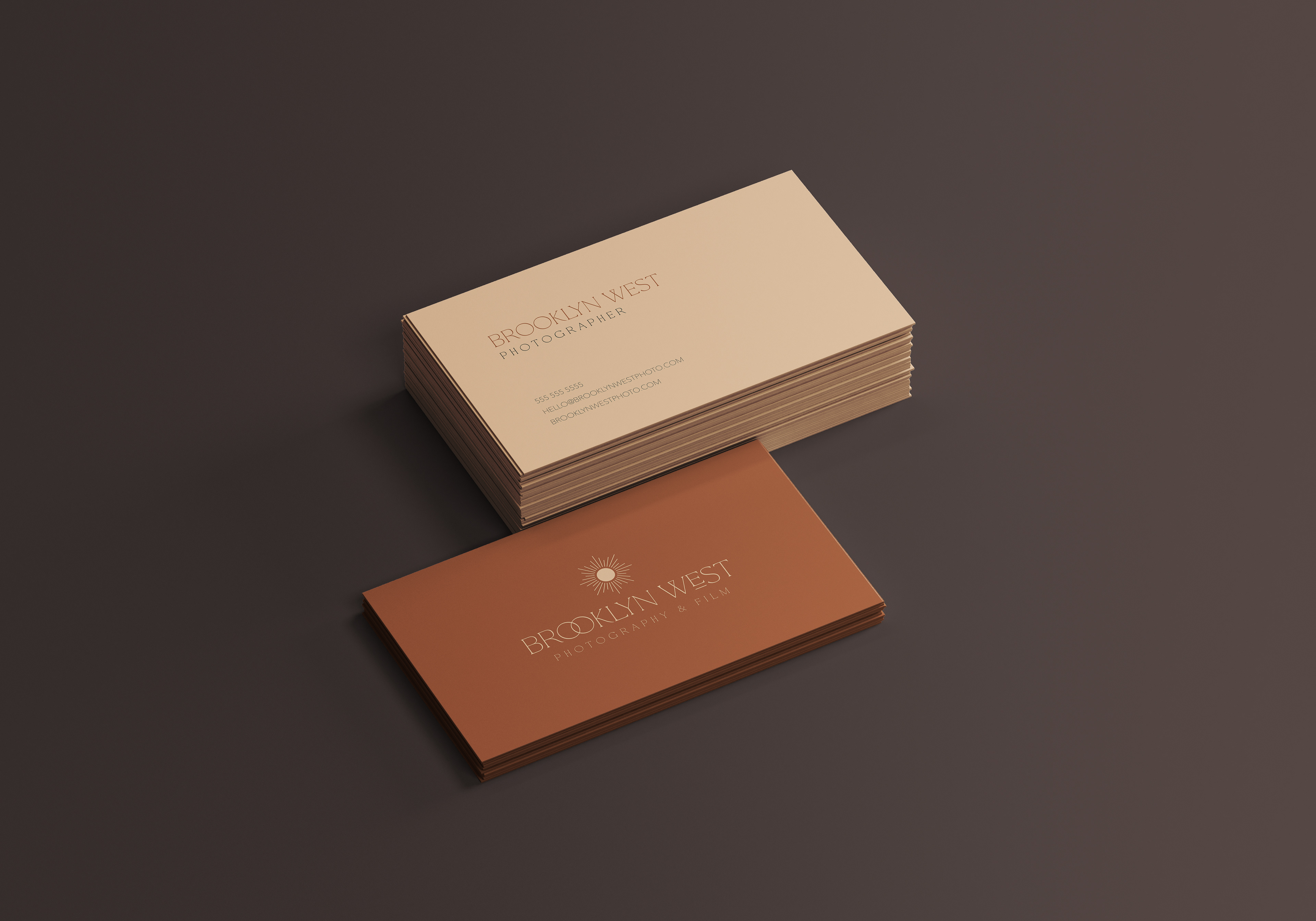 Business cards with Brooklyn West branding stacked next to each other, in brand colors.