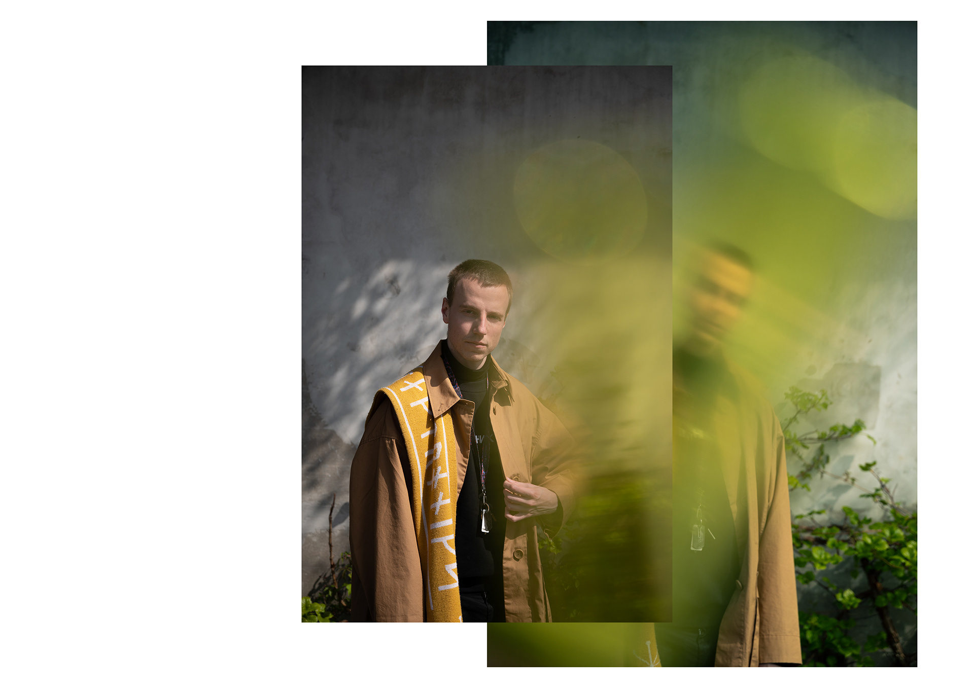 a portrait of a guy in a light brown coat