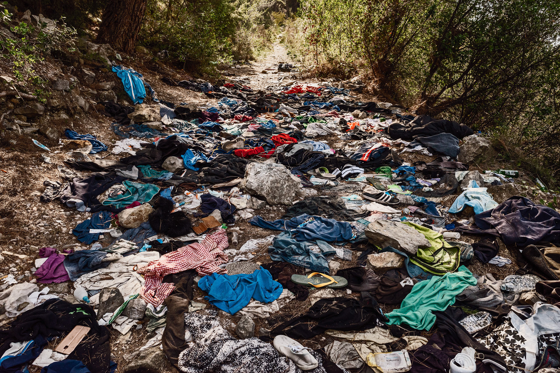A tragically colourful carpet of clothes at the start of the 'Death Pass' near Grimaldi. This is a mountain path that allows one to cross the French border clandestinely; people on the move often dispose of their belongings shortly before entering France, so that they walk lighter and are less visible to the eyes of the Gendarmerie.