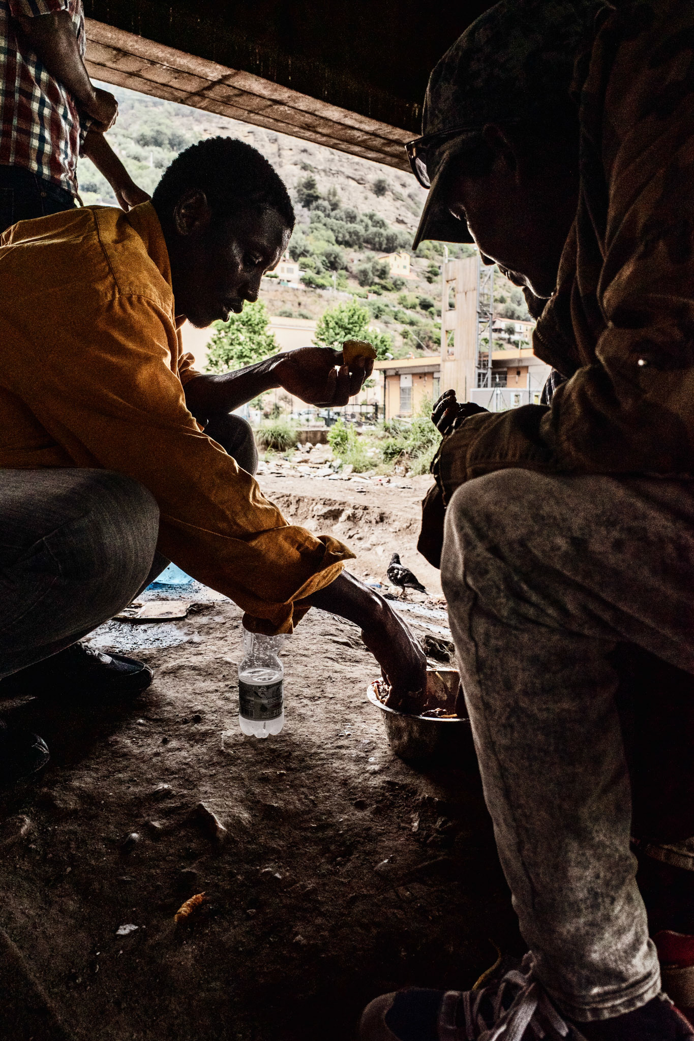 Some young people have lunch in the camp in front of the municipal cemetery
