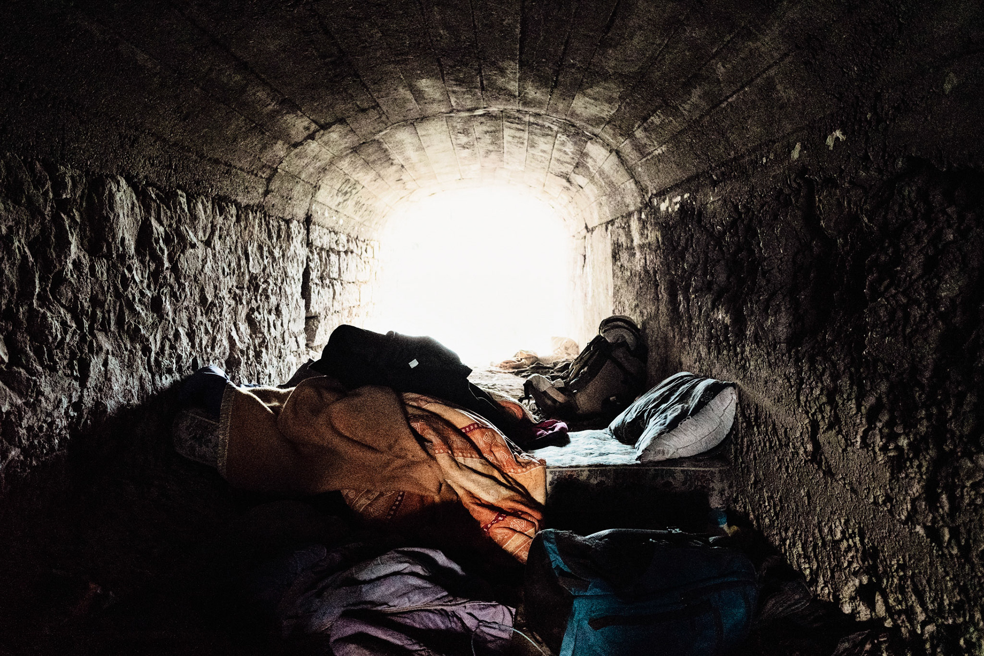 This camp is located in one of the tunnels that cross the railway bridge from Ventimiglia to France and Cuneo. It is a dark and gloomy place but it is considered safe for being in the shade and away from prying eyes.