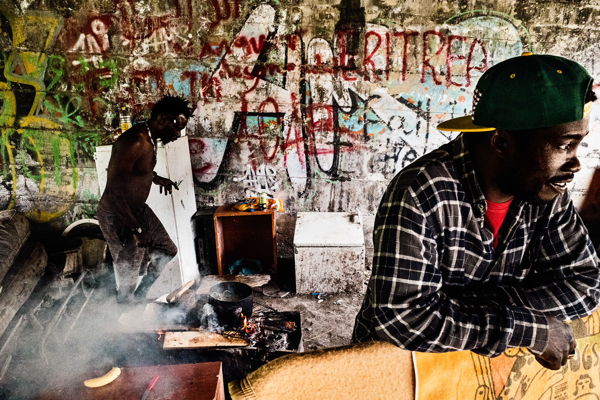 A moment of ordinary everyday life in the camp under the flyover. These boys are preparing lunch with money scraped together after begging in the supermarket car park. Water for cooking is taken from the cemetery with large plastic bottles.