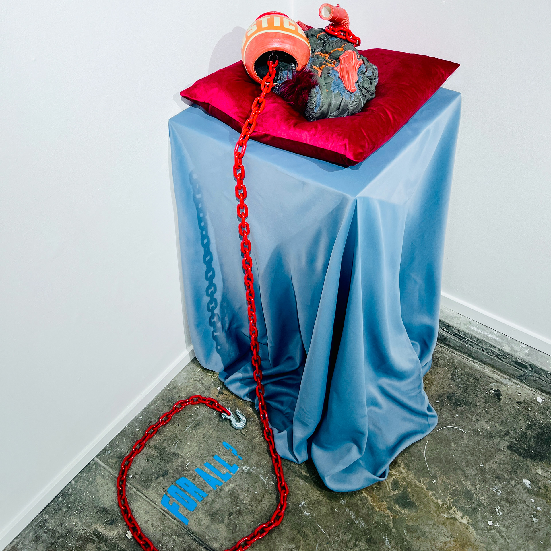 Justice, 2024, glaze on low-fire terracotta, faux hair, steel chain, vinyl, 16 x 14 x 8 in