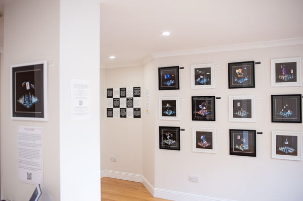 Scotland's Chequered Throne collection in alternating black and white frames on a white wall in a gallery.