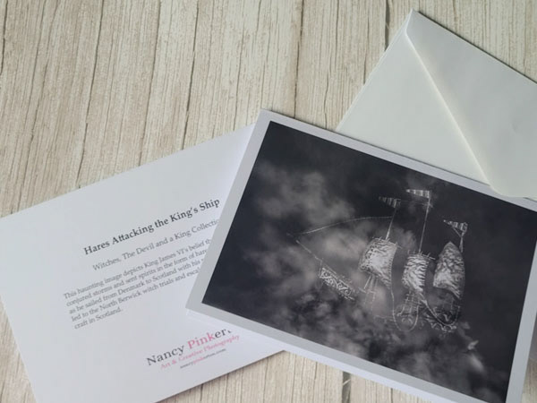 Image showing black and white photo card of the ship was smoke next to envelope and back of card showing write up of the image.