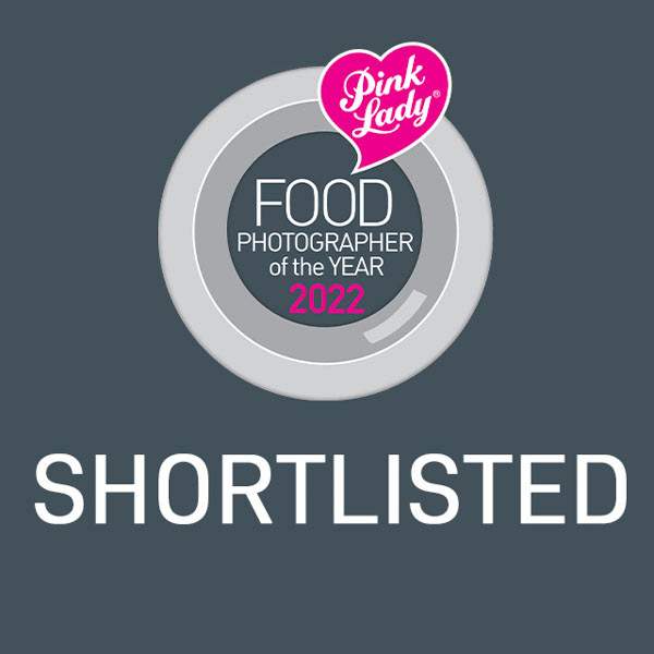 trust stamp grey with pink acents that says pink lady food photographer of the year 2022 Shortlisitedo