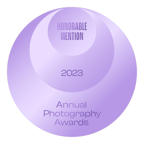a trust stamp of a purple circle with text that says Honorable mention 2023 annual photography awards
