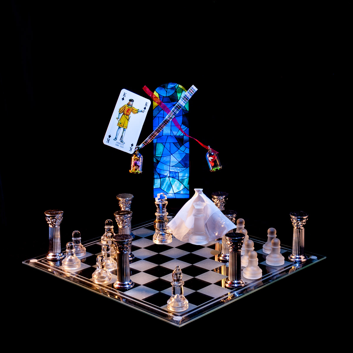 Photographic art that tells the story of King James IV’s marriage which aligned the Royal Stewarts to the English Throne, using a chessboard, playing card and objects.