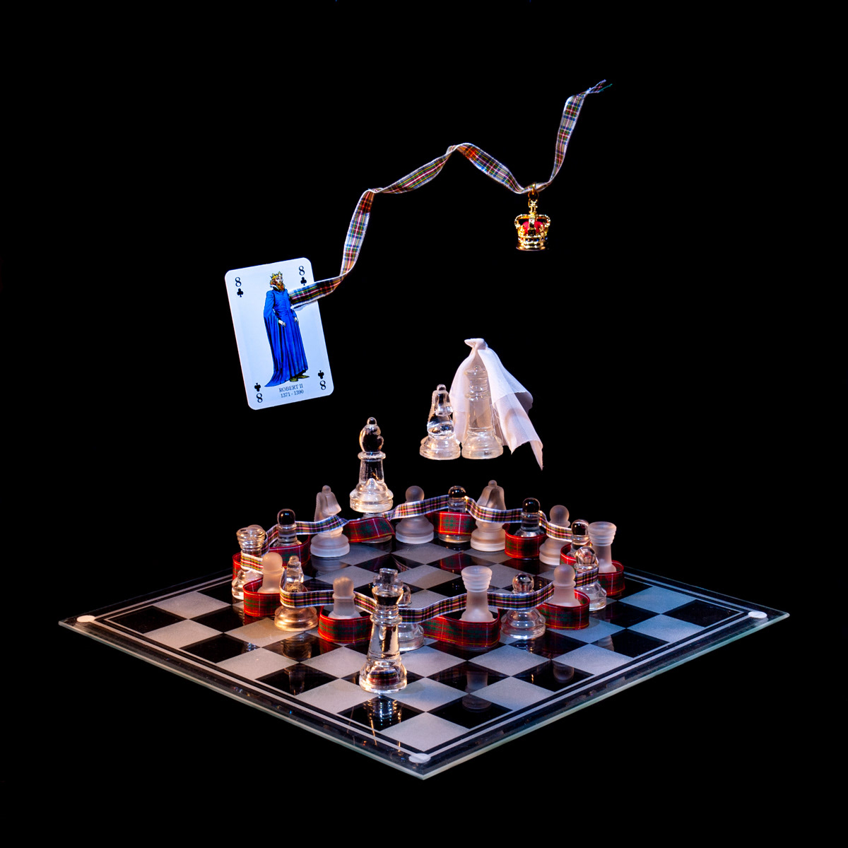 Photographic art that tells the story of Robert Stewart became the first Stewart King of Scotland, using a chessboard, playing card and objects.