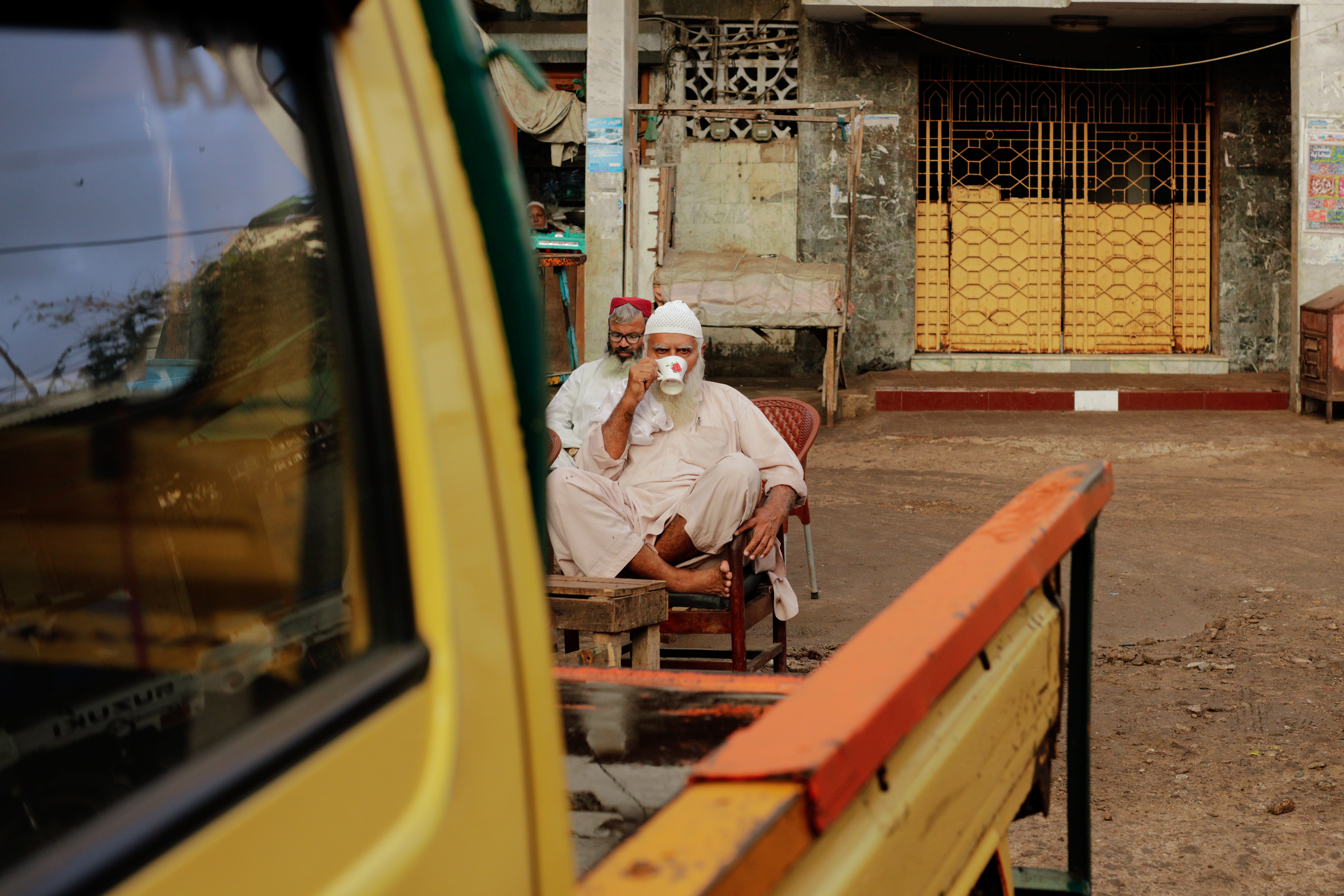 An old man sips tea early in the morning in Lee Market, Karachi, Pakistan on December 25th 2021.