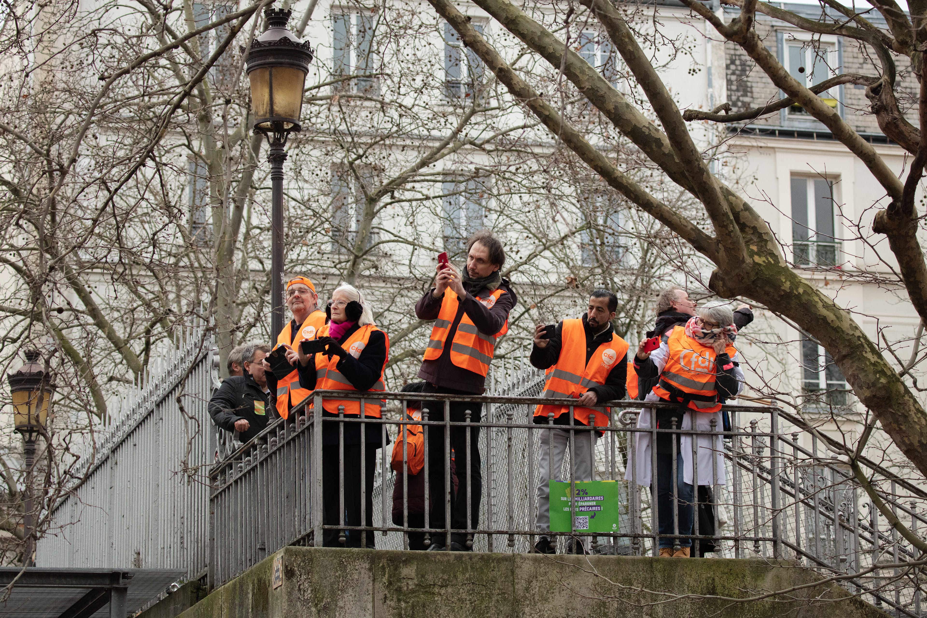 Demonstrators witness the rally passing by against a pensions overhaul in Paris, France, January 31st 2023.