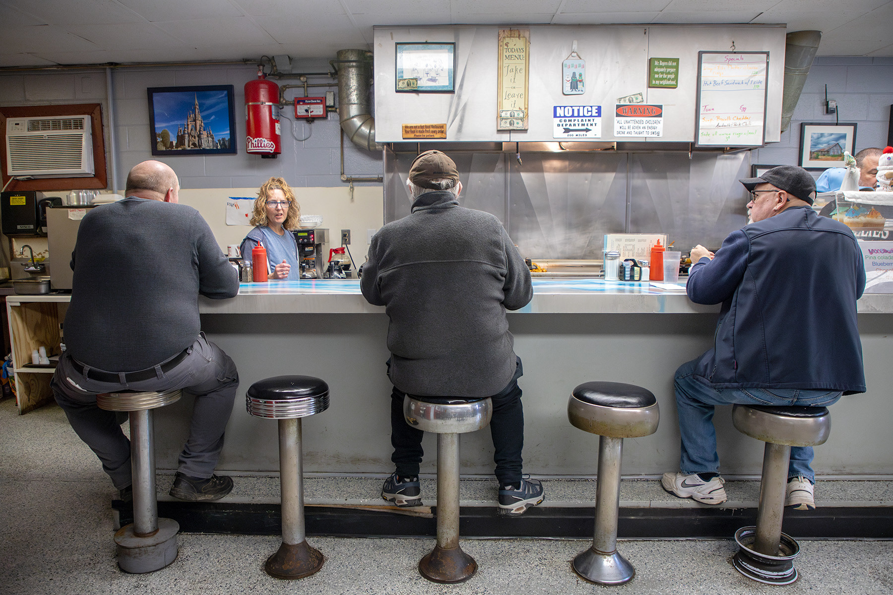 Consumers sit at the counter and chat with the server Amy Magdon Wednesday, Mar. 6, 2024 at Lincoln Street Diner, Ithaca, NY. Photo by Xinyi Qin.