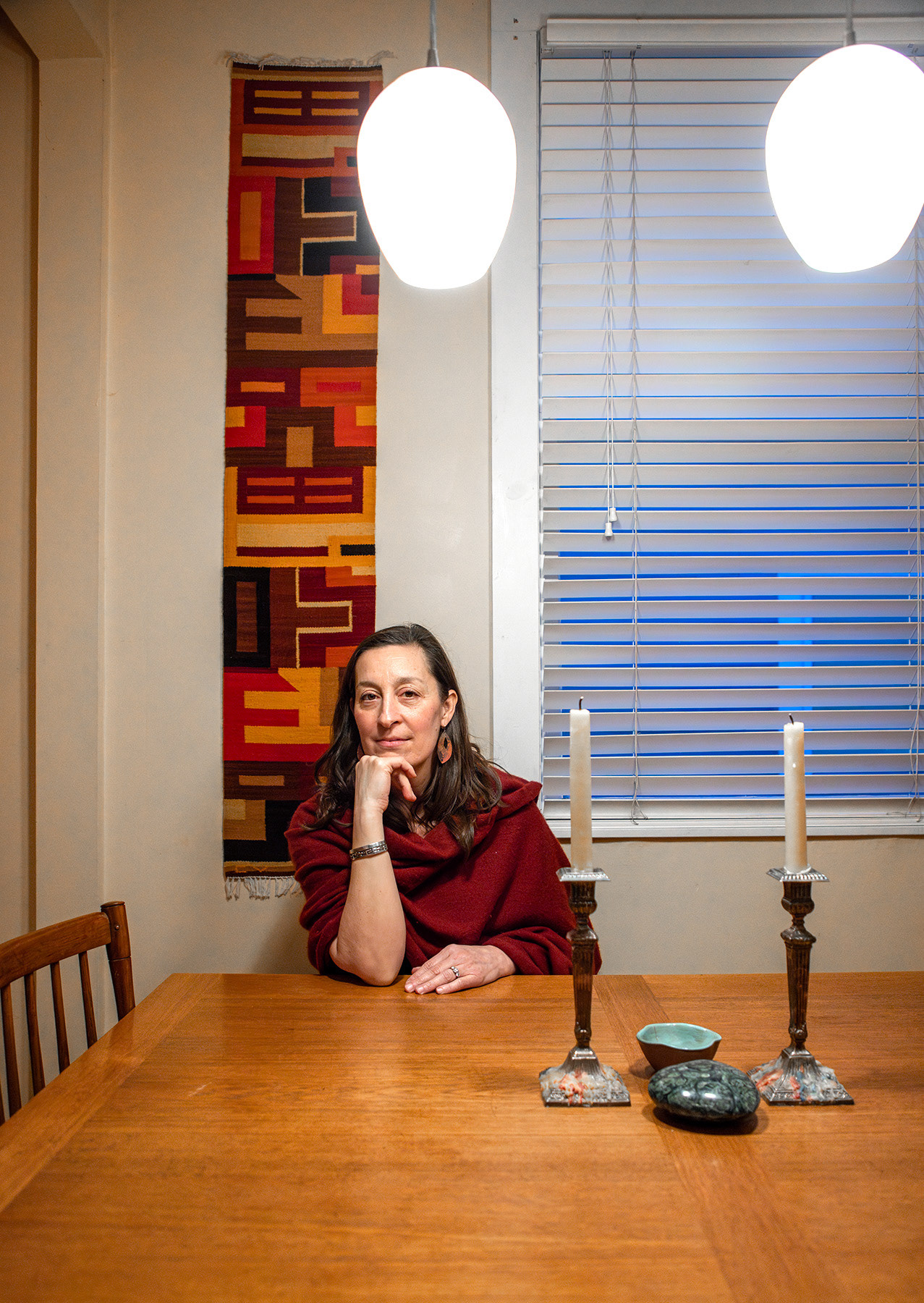 Freelance therapist Suki Montgomery Hall sits in front of the dinning table at her home Friday, Mar. 1, 2024 at 412 Lincoln Street, Ithaca, NY. Hall lives in a duplex with her friend, a retired chemistry teacher who is 10 years older than her. Photo by Xinyi Qin.