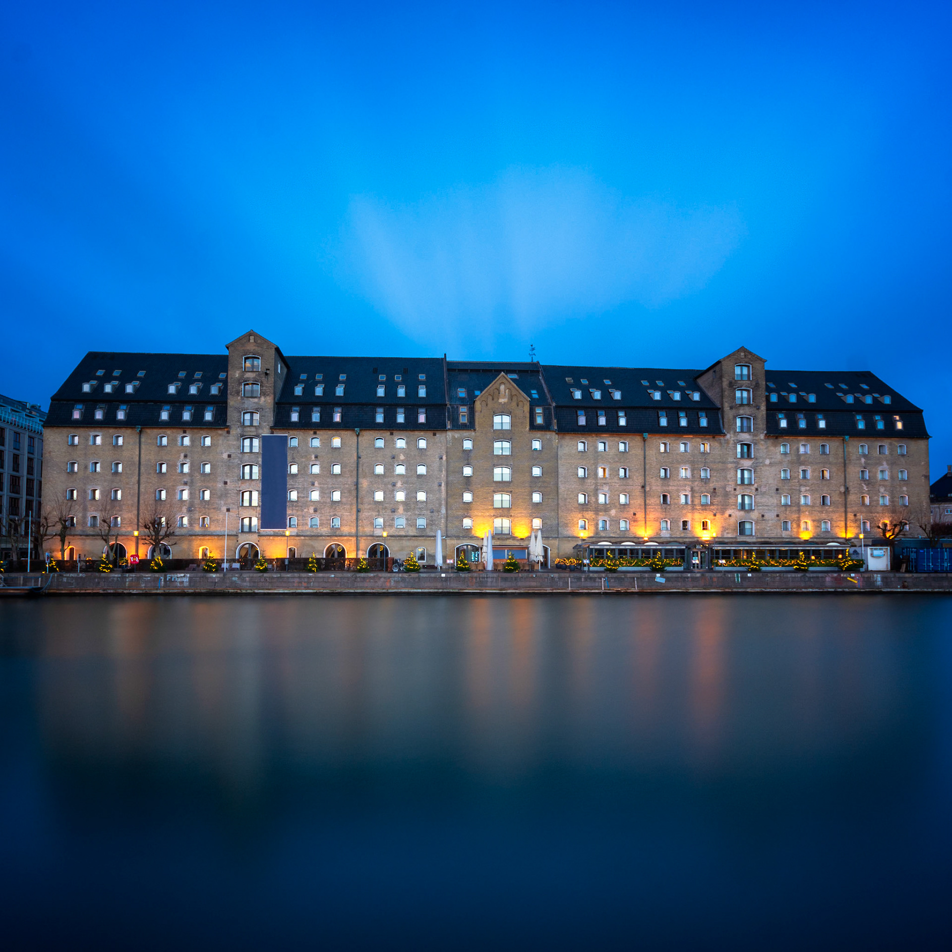 Blue hotel reflected in water