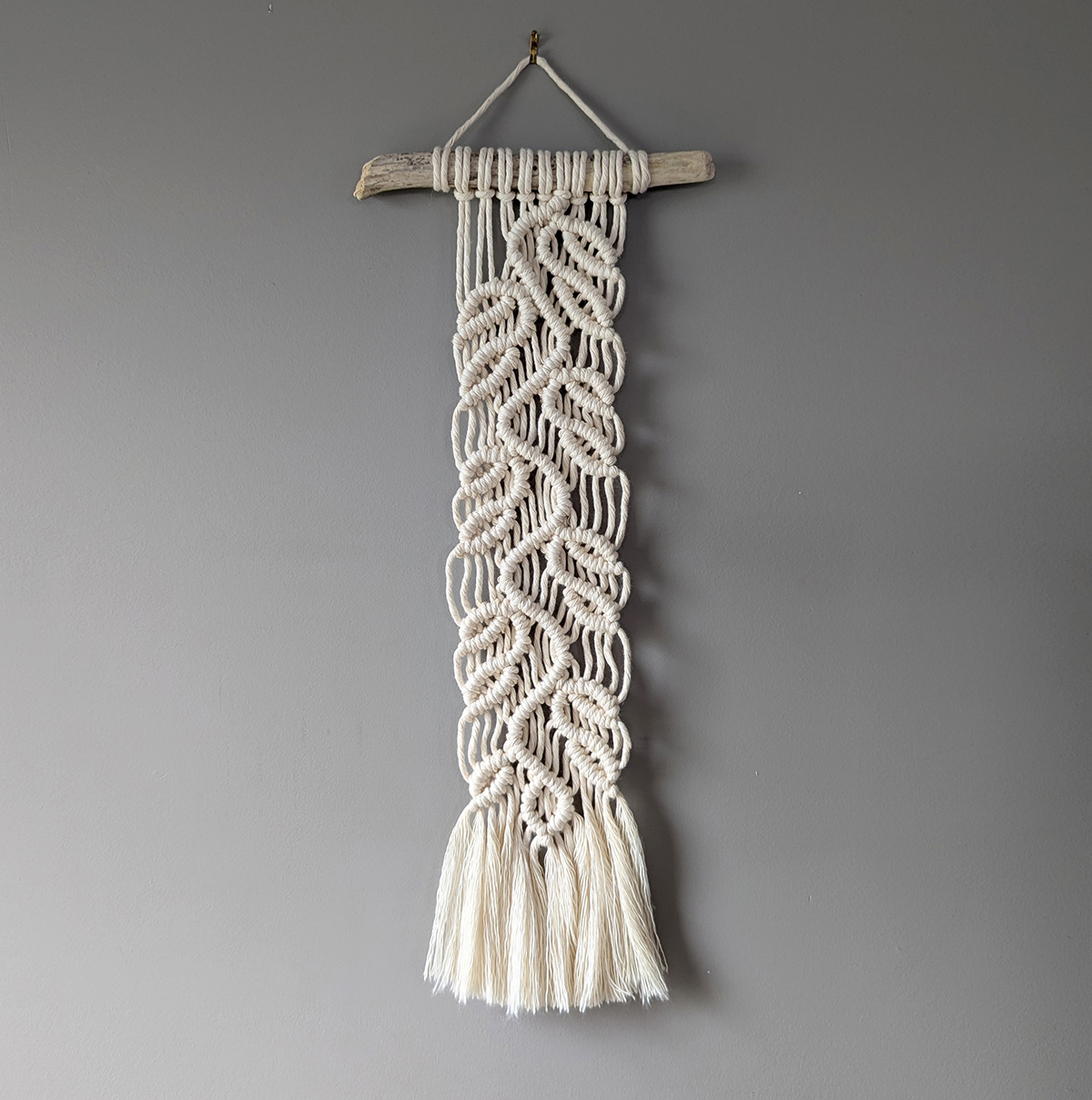 Macrame wall hanging with vines and leaves pattern